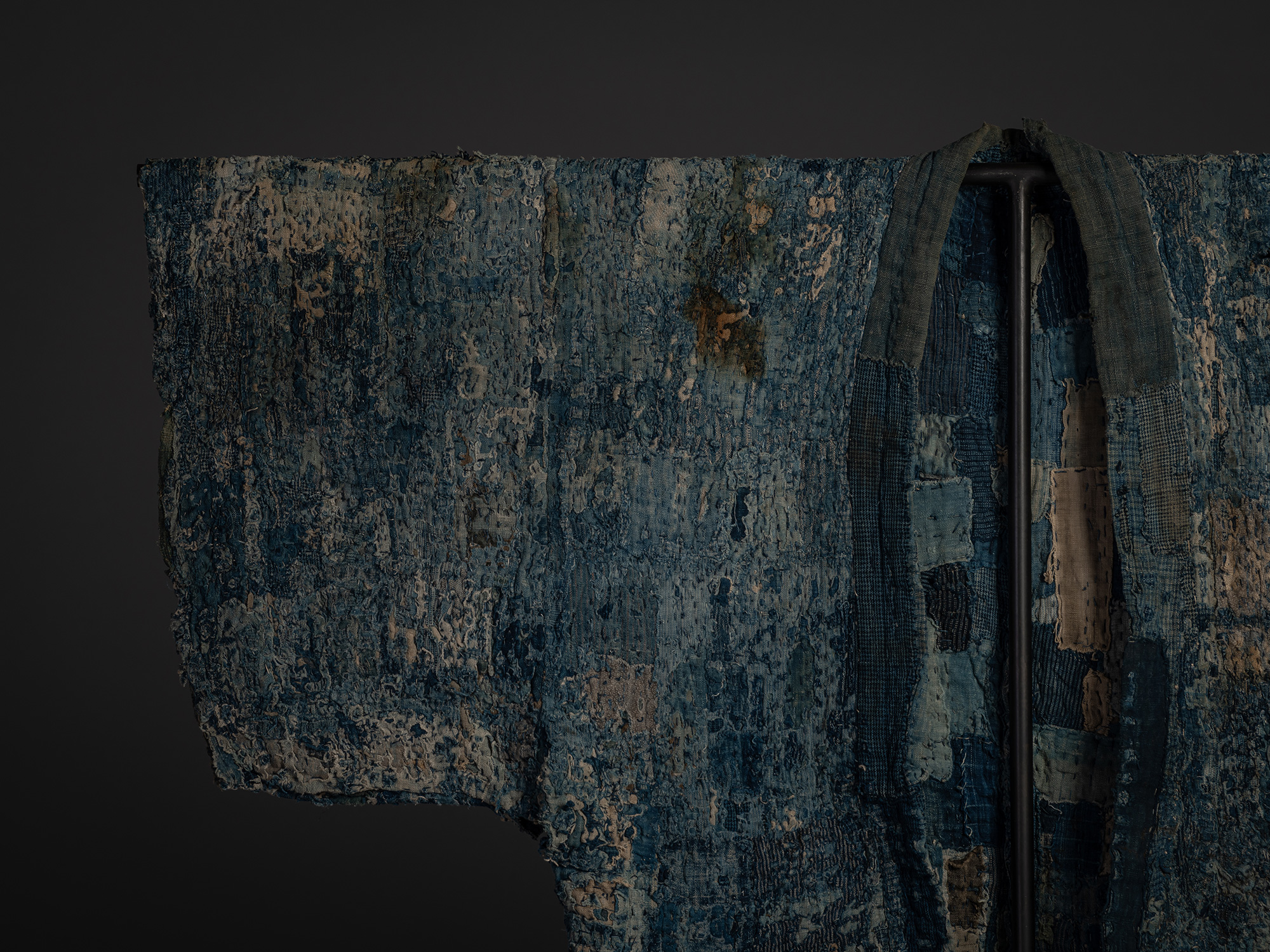 Close-up detail of the right sleeve and front opening of a Japanese boro hanten. Varied indigo...