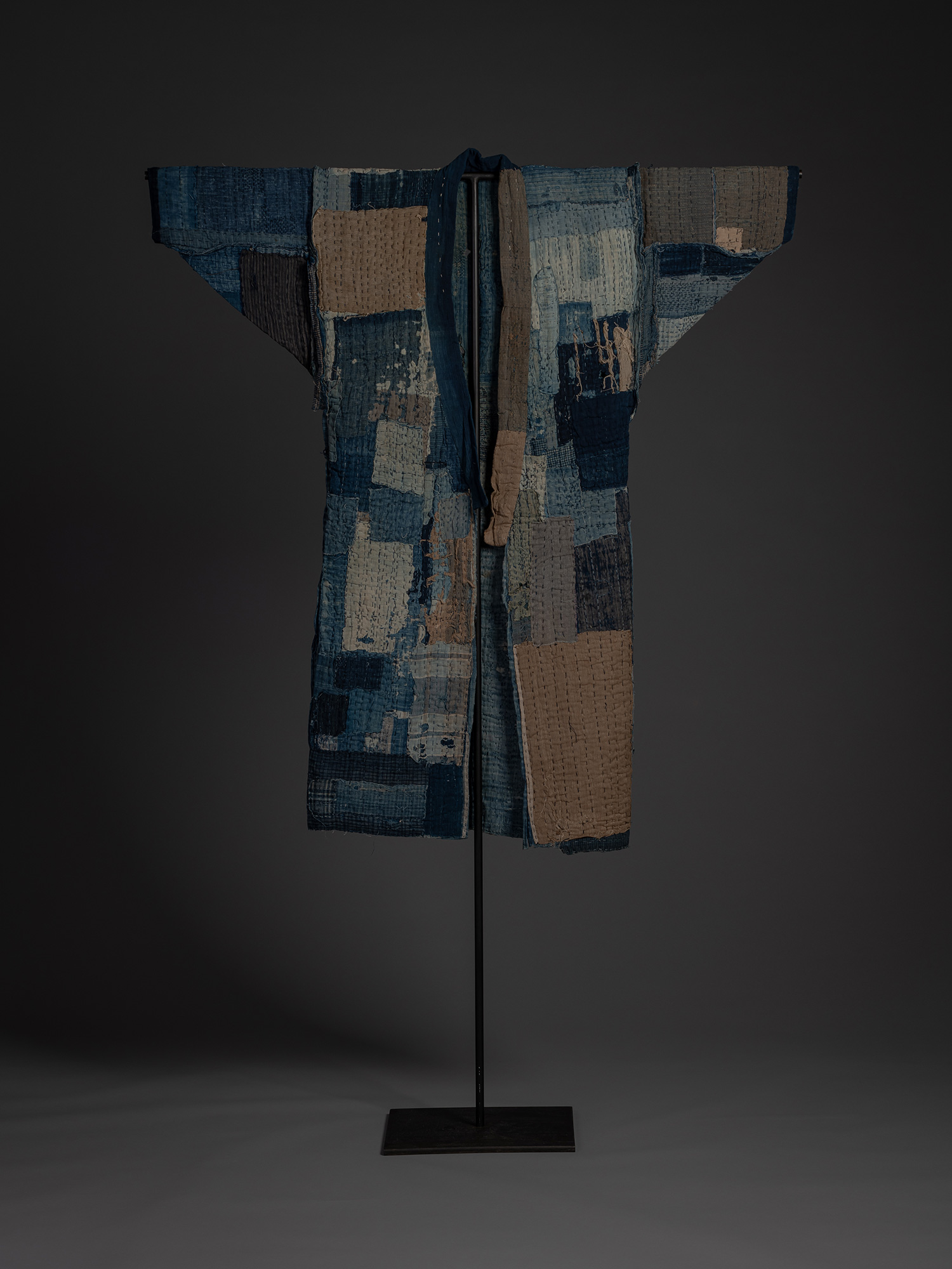 Full front view of a late 19th–early 20th century Japanese cotton boro kimono displayed on a stand....