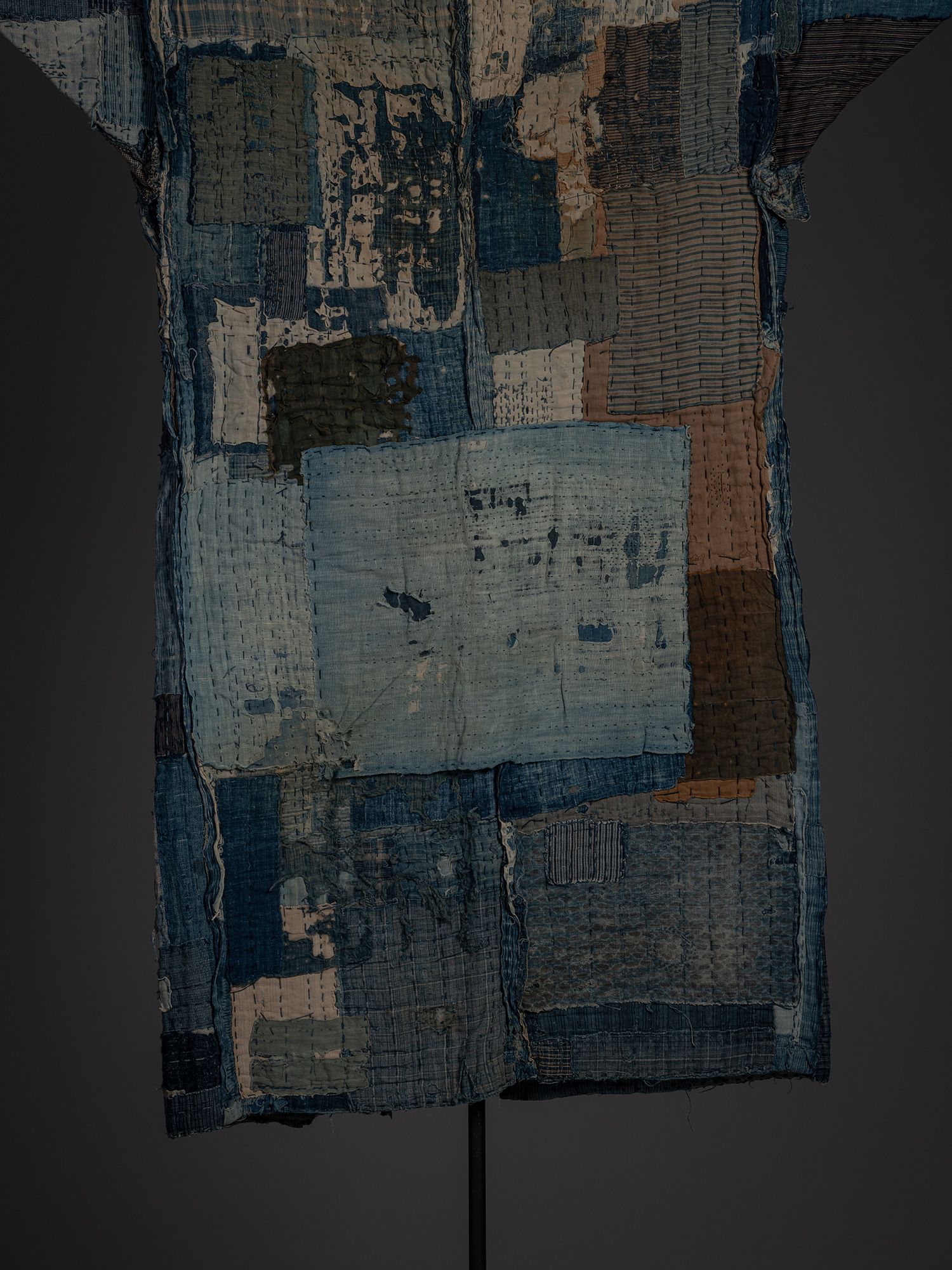 Close-up of the back of the kimono showing a large pale blue rectangular patch surrounded by smaller...