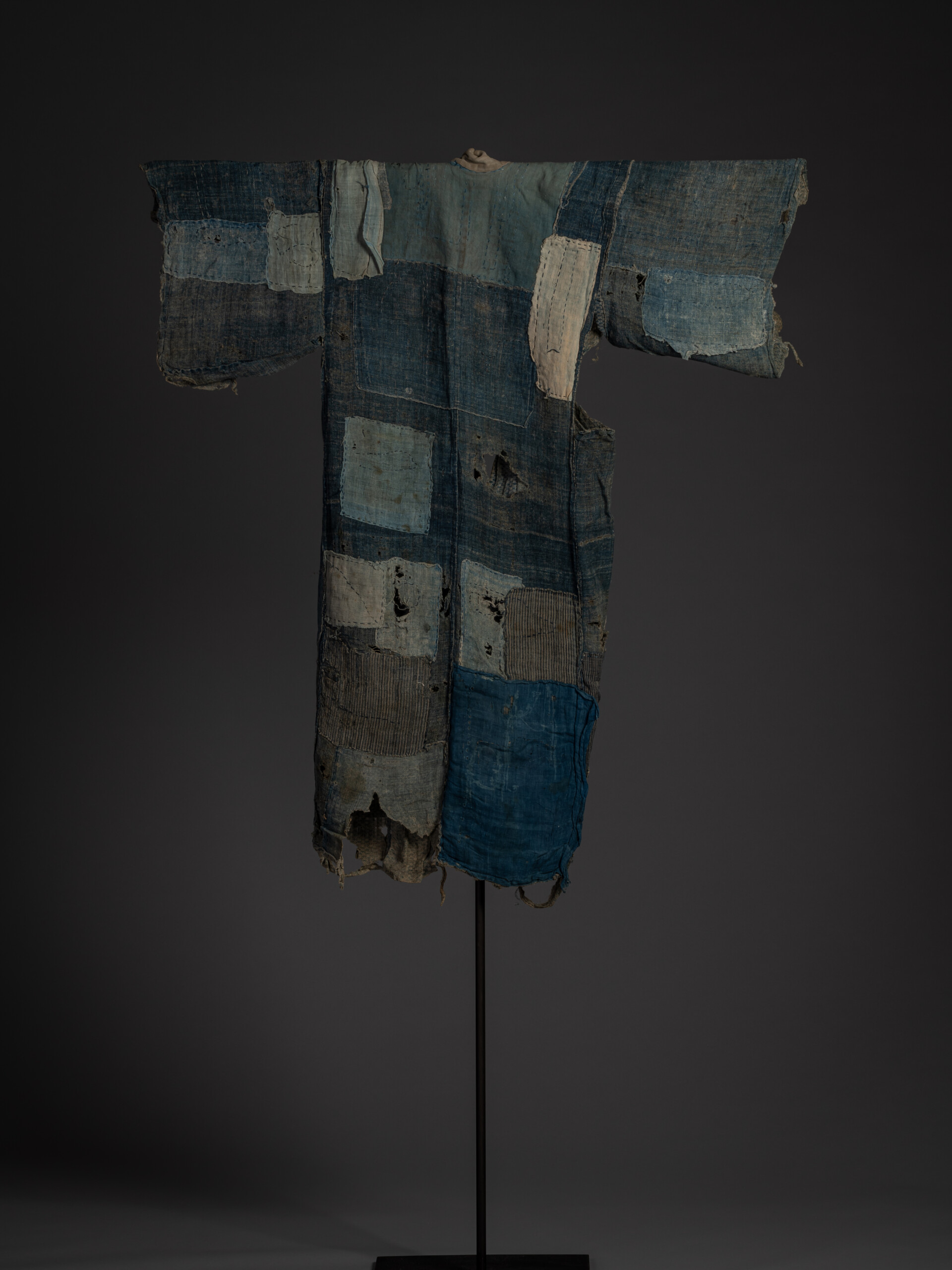 Full back view of the boro kimono showing a patchwork of faded indigo, pale blue, and off-white...