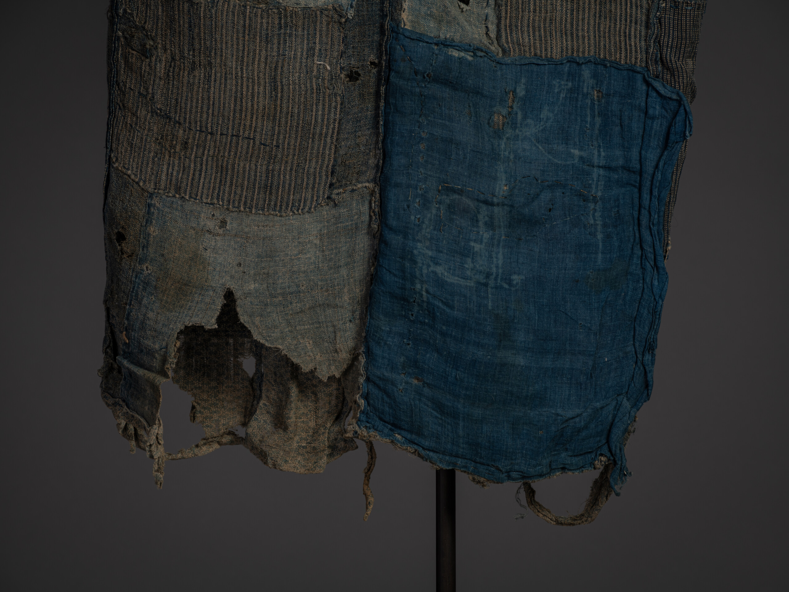 Detail of the lower front section of the kimono showing extensive wear, large losses, and layered...