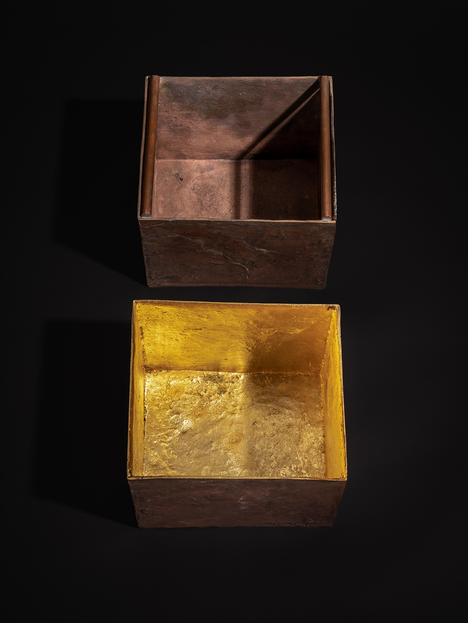A high-angle, top-down aerial view of Koji Hatakeyama's bronze vessel Doing Little - Large against...
