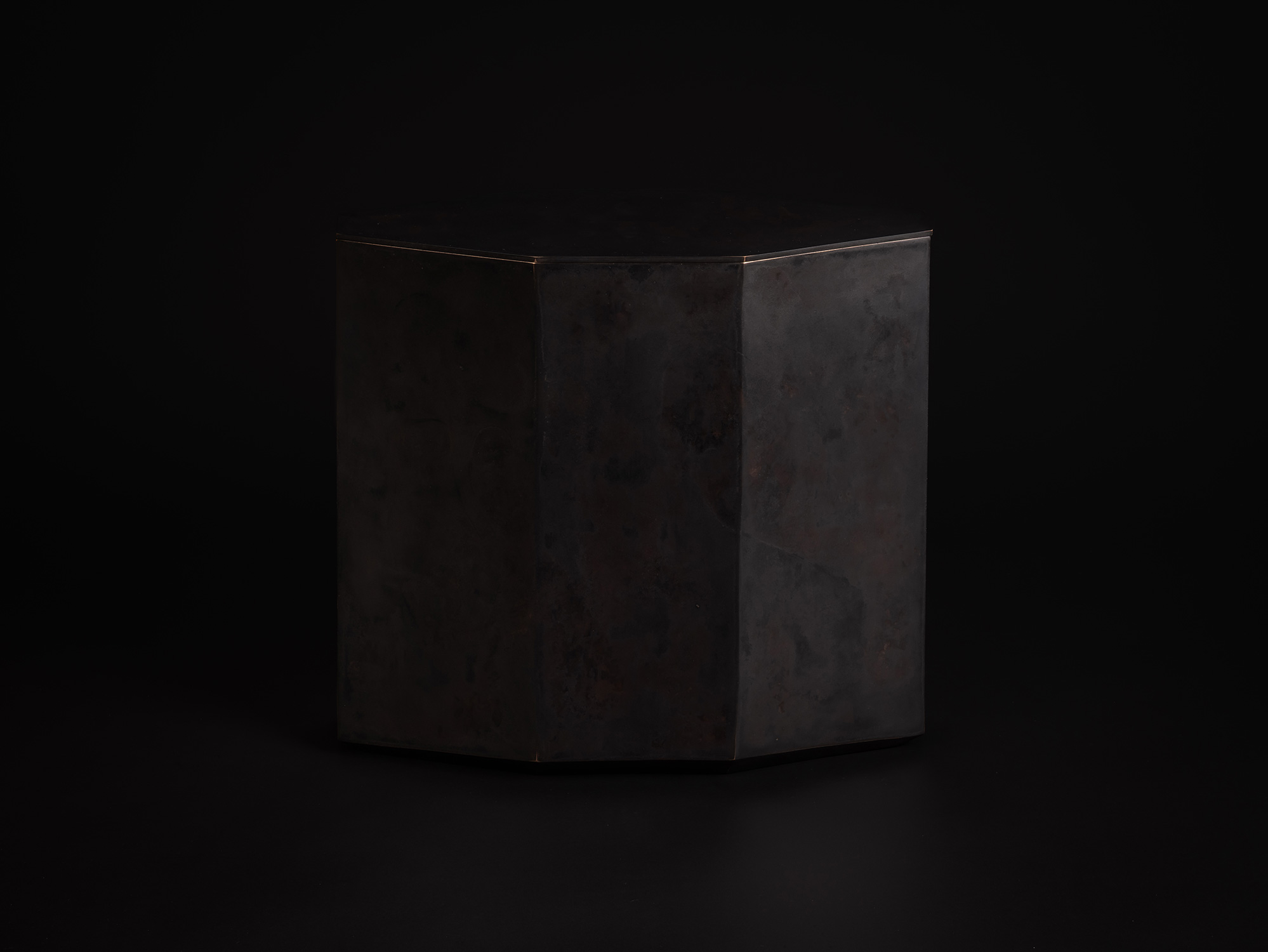 Eight Faces by Koji Hatakeyama, viewed from the front, showing a faceted bronze vessel with eight...