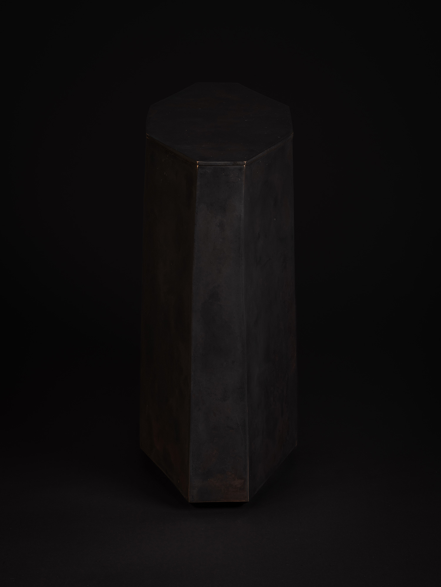 Side view of Eight Faces by Koji Hatakeyama, featuring the tall geometric profile of the bronze...