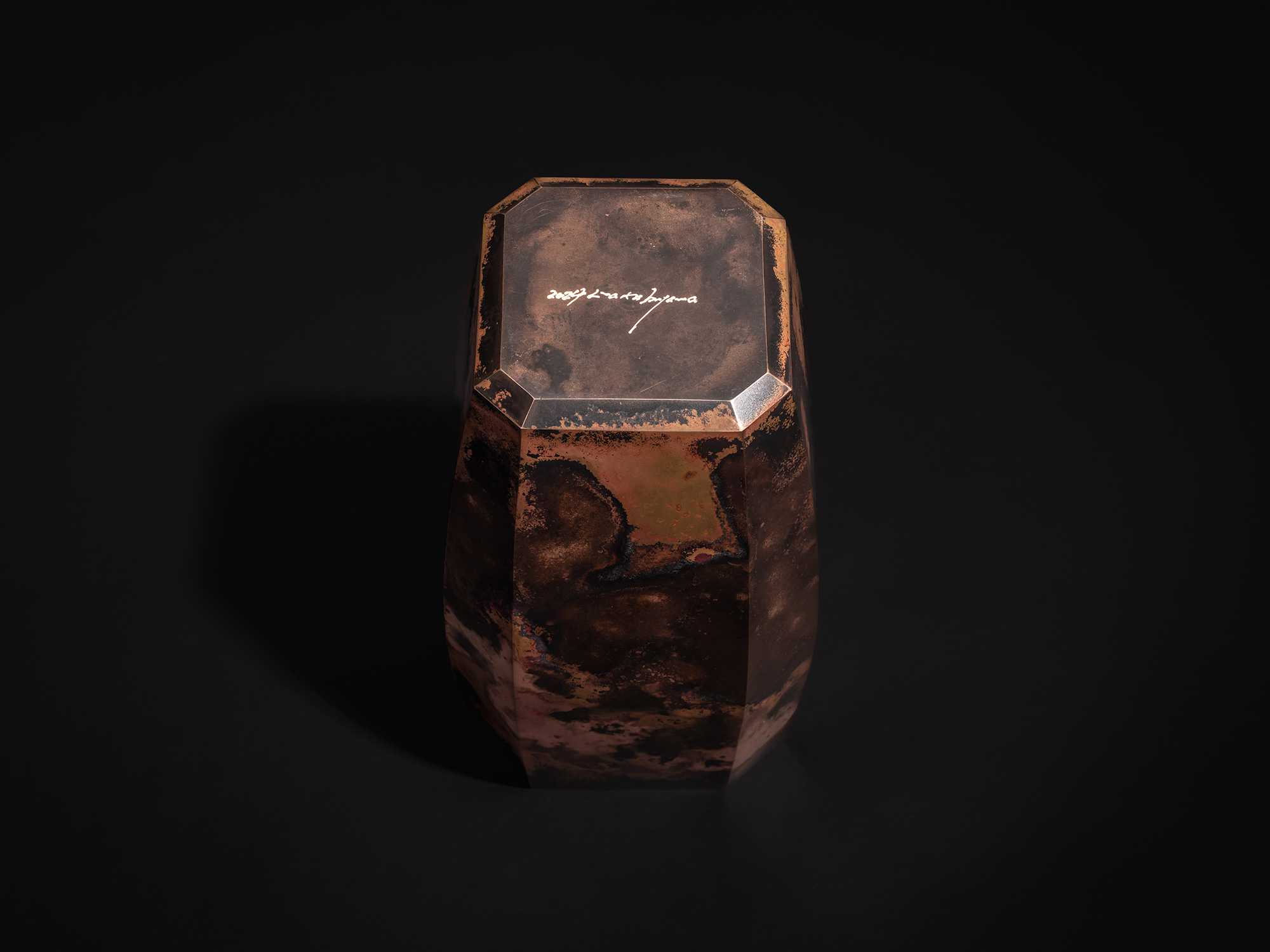 Bottom view of Eight Faces XVI by Koji Hatakeyama showing the faceted octagonal base with the artist’s...