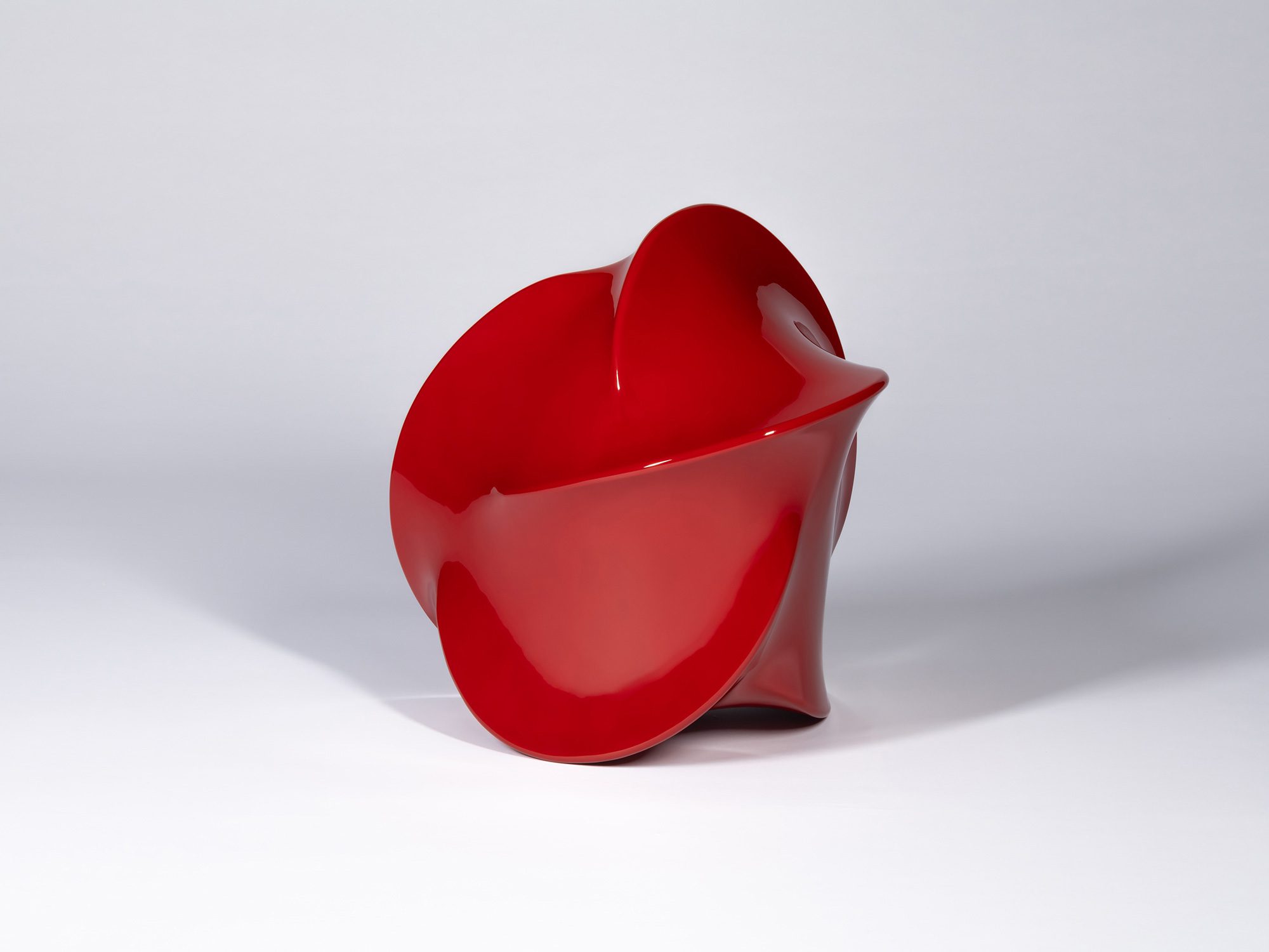 Deep red urushi lacquer sculpture by Genta Ishizuka with a smooth, flowing, asymmetrical form,...