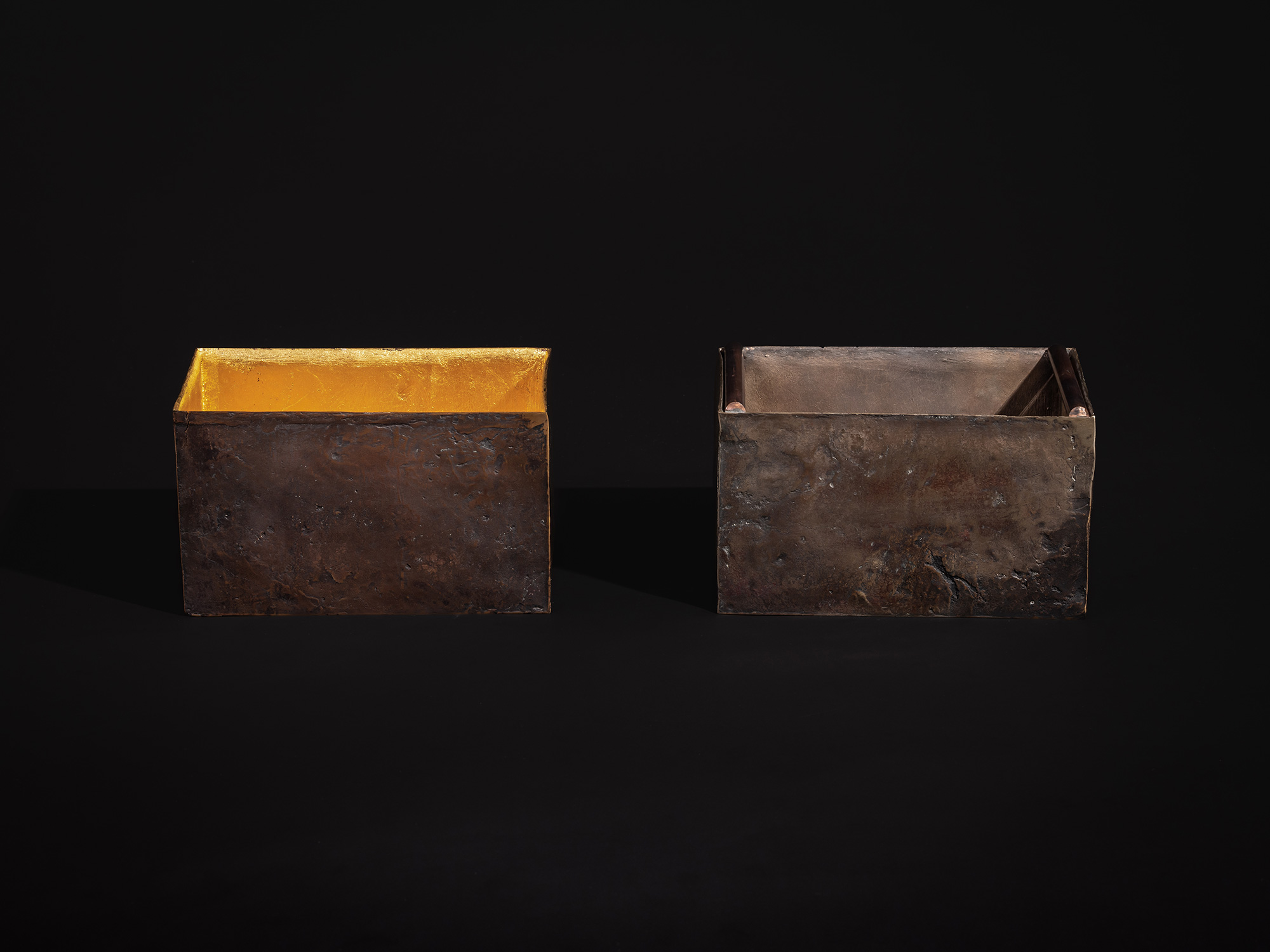 Front view of the sculpture displayed as two separate elements. The left vessel reveals a radiant...