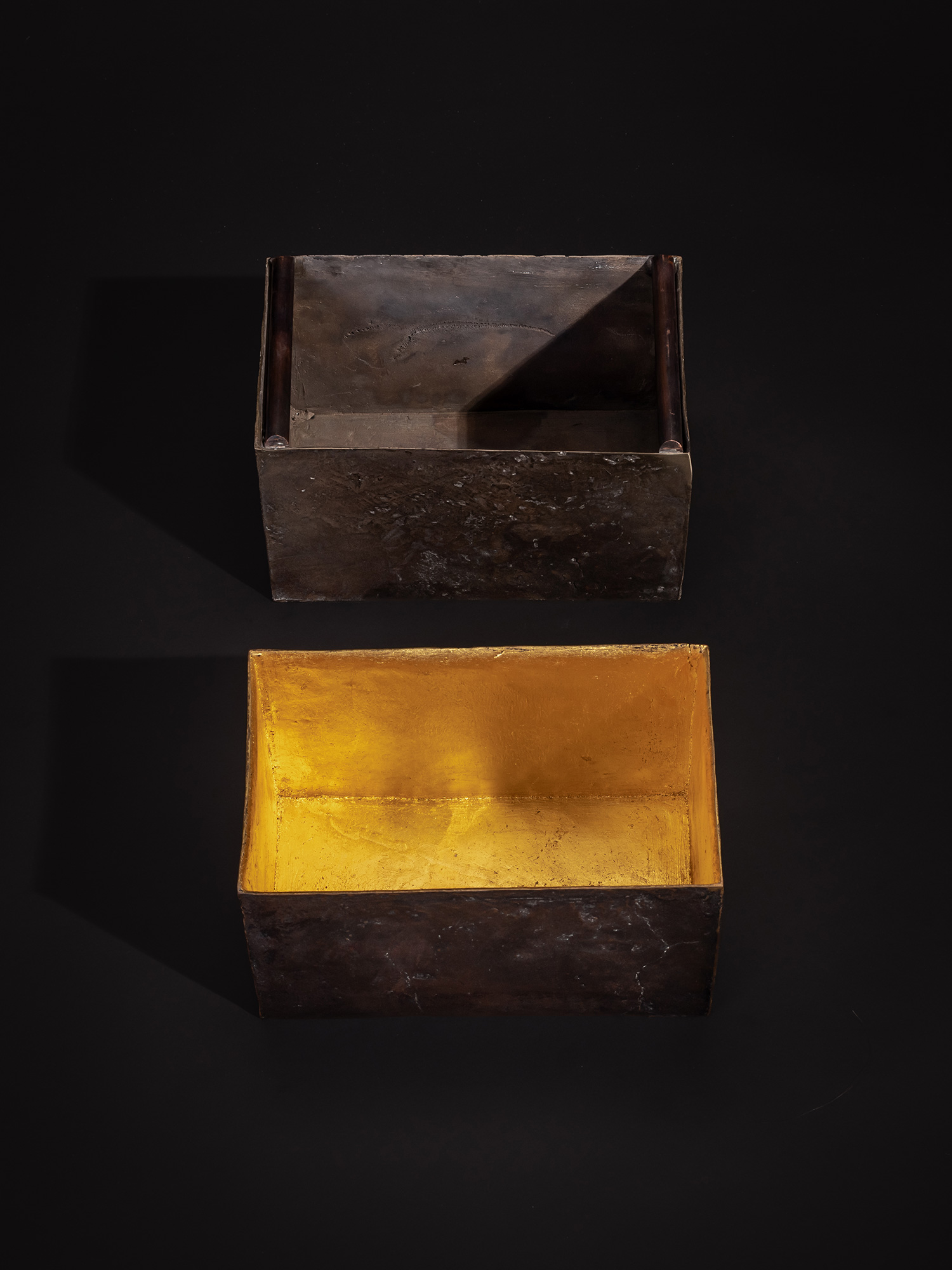 Overhead view of Inner Existence showing two separate bronze box forms placed one above the other....