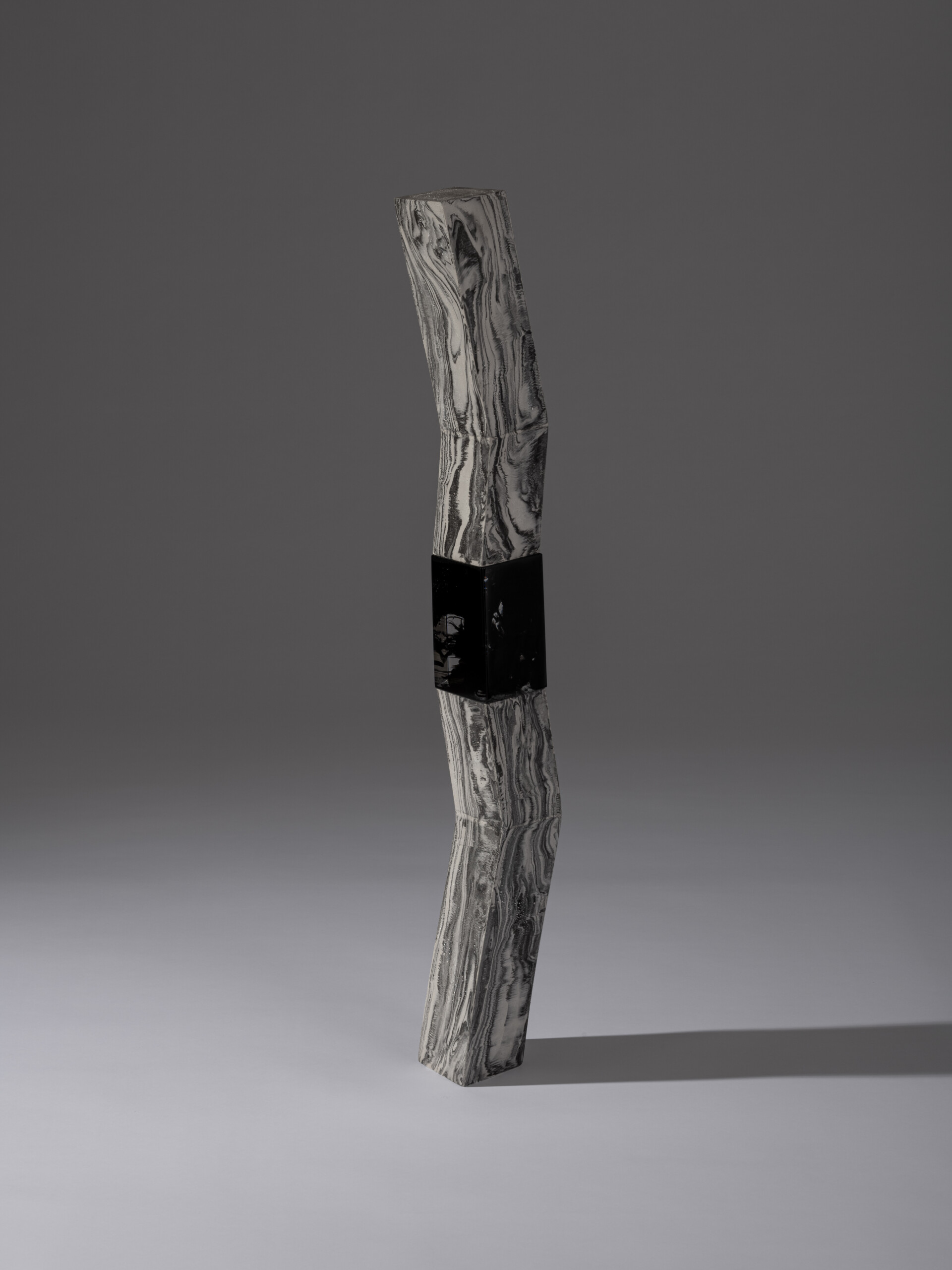 Photograph of a tall, vertically stacked contemporary ceramic sculpture from the Monolith series...