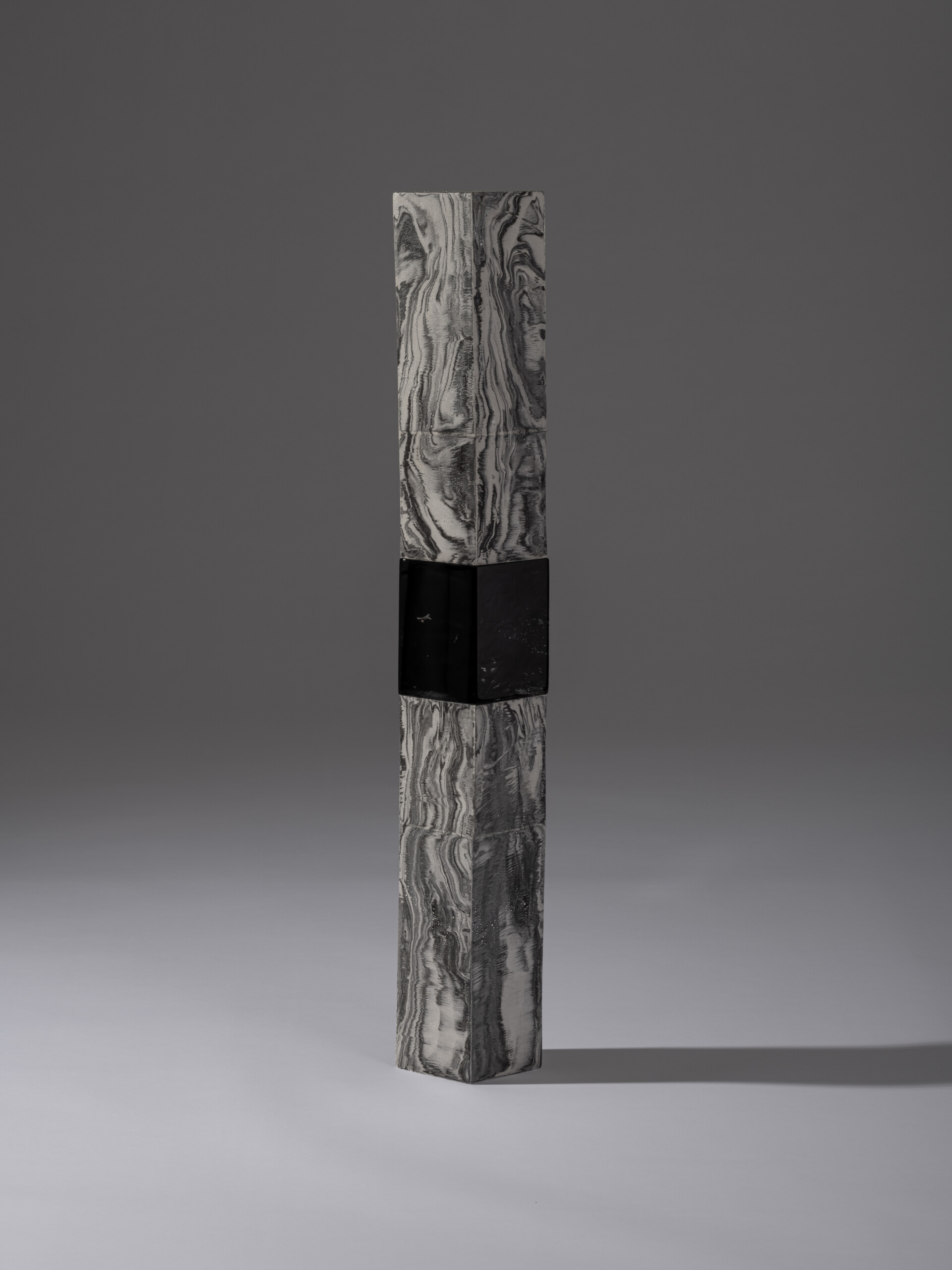 Side view of a tall, vertically stacked contemporary ceramic sculpture from the Monolith series...