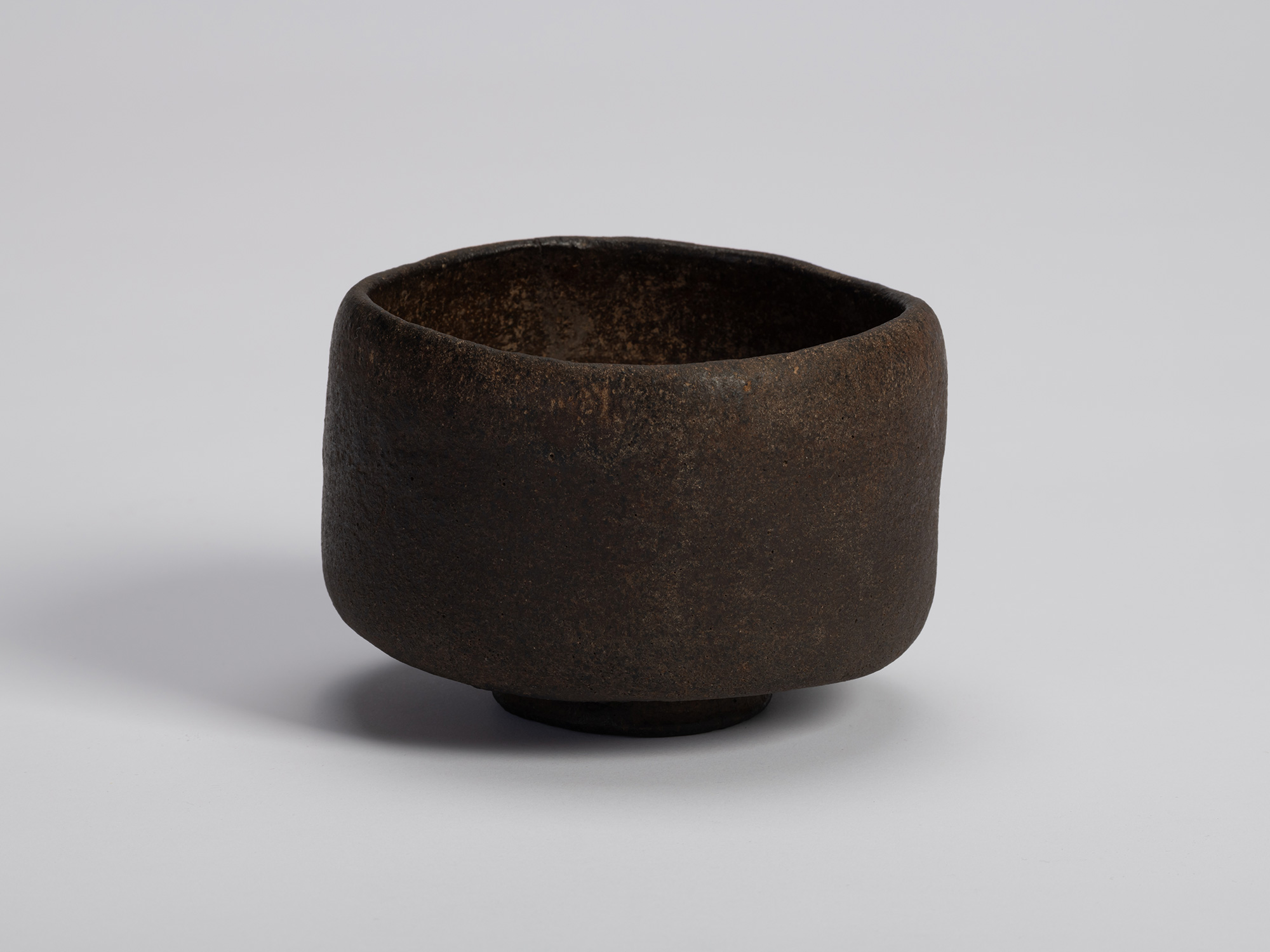 Raku tea bowl entitled Musashino by Chōjirō, a hand-formed black chawan with thick rounded walls...