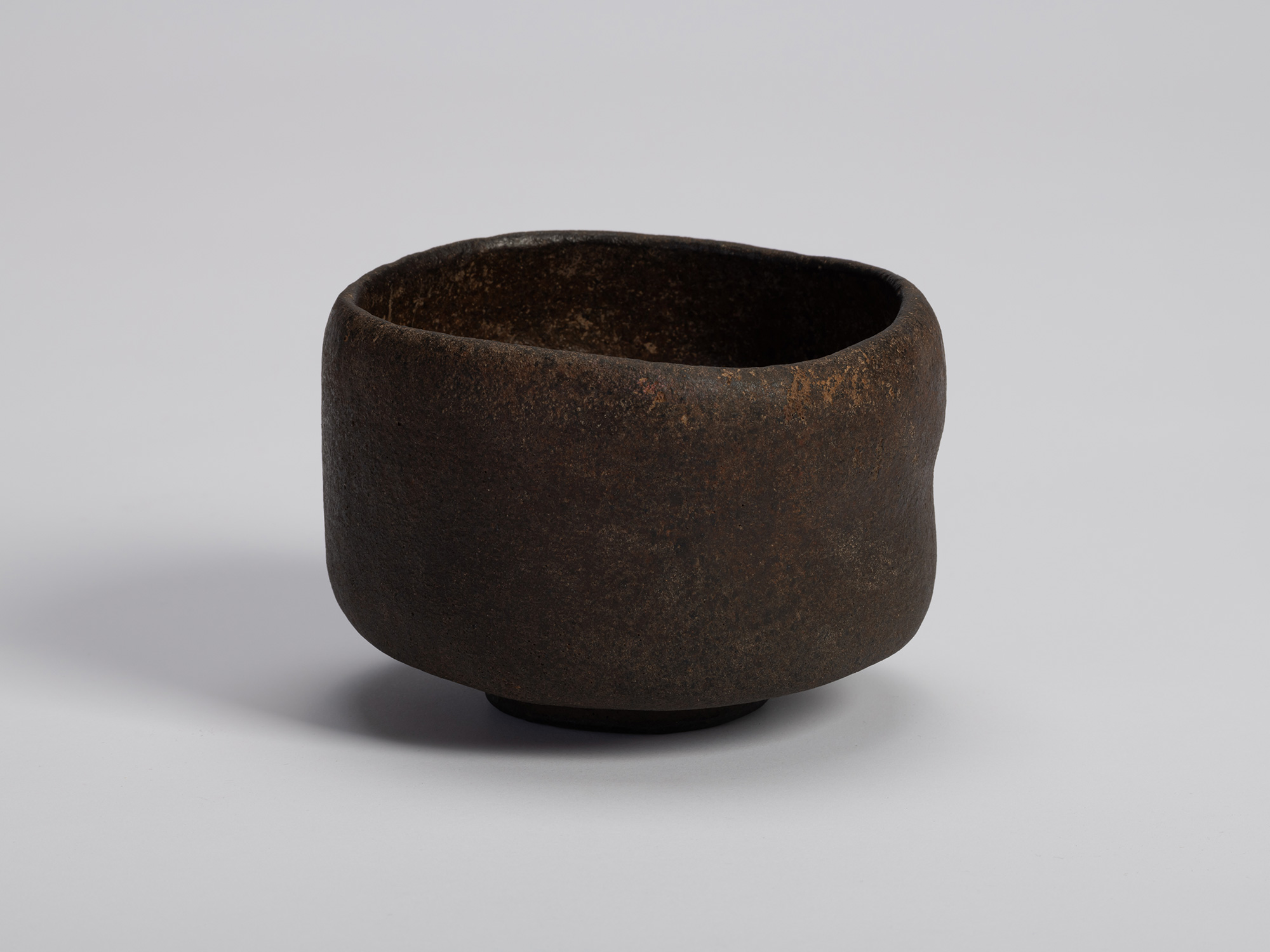 Raku tea bowl entitled Musashino by Chōjirō, a hand-formed black chawan with thick rounded walls...