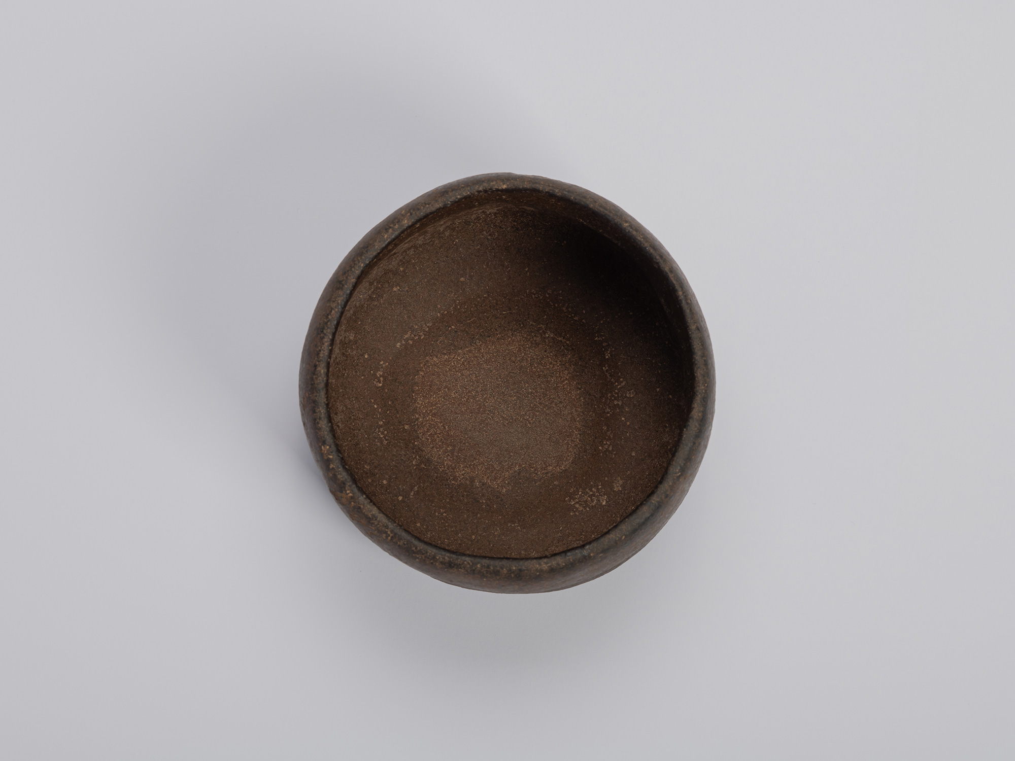 Interior (mikomi) of Chōjirō’s Raku tea bowl Musashino, showing its gently rounded form, matte...