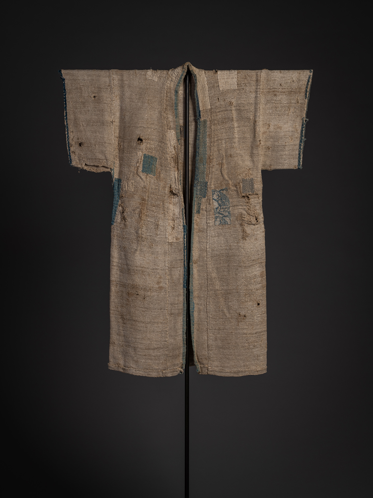 Front view of a late 19th-century okusozakkuri garment woven from okuso (hemp waste) and hemp fiber,...