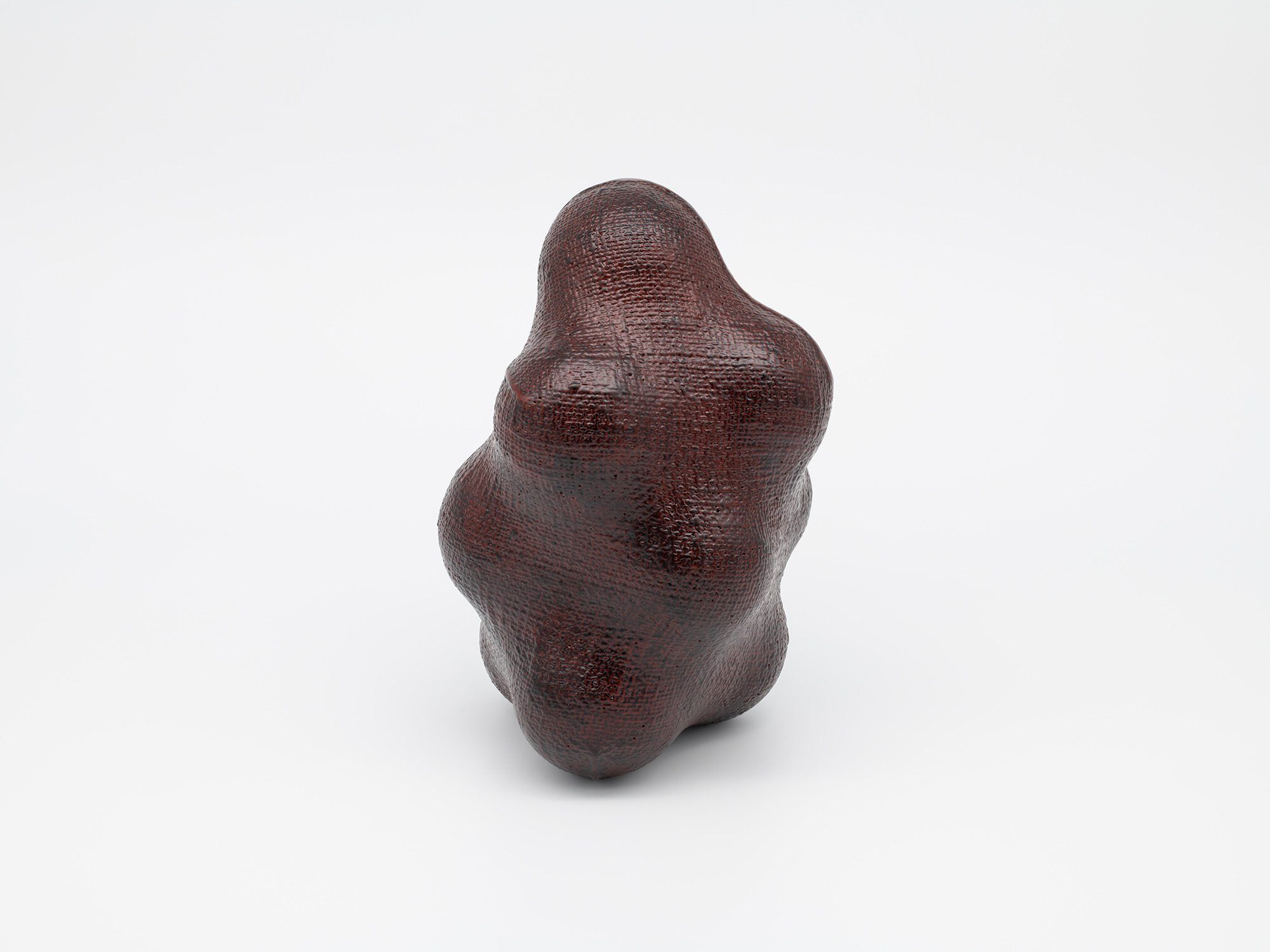 View of Genta Ishizuka's sculpture Surface Tactility Suture Line #1 against a plain white background....
