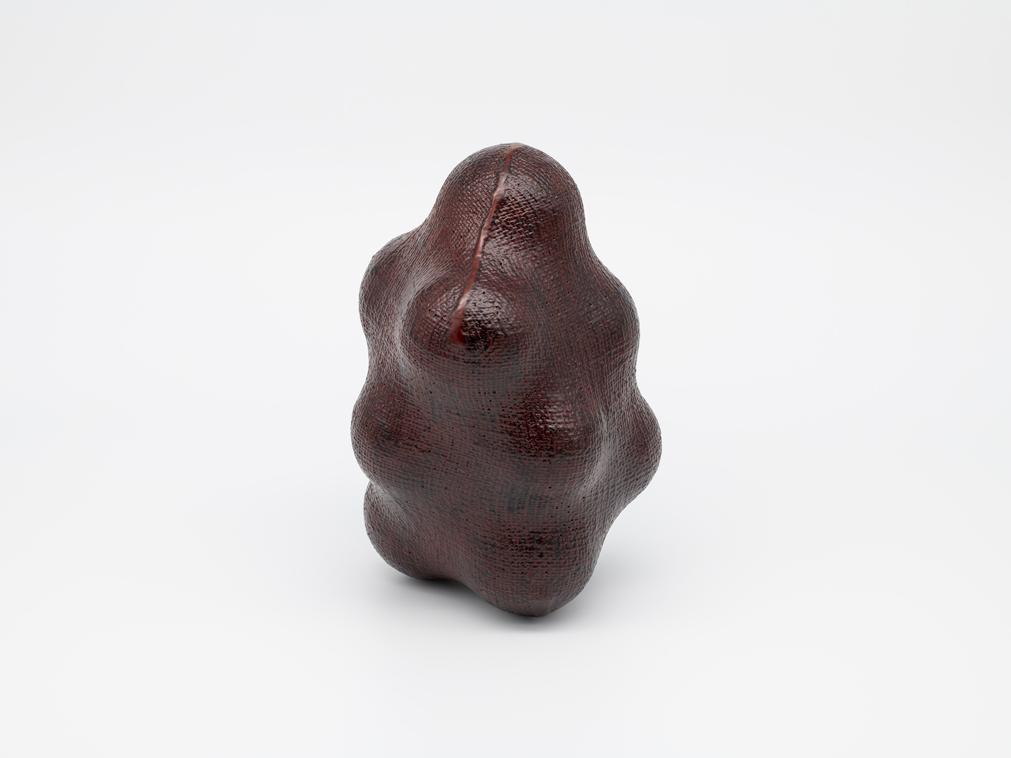 A side profile view of the lacquer sculpture Surface Tactility Suture Line #1 by Genta Ishizuka....