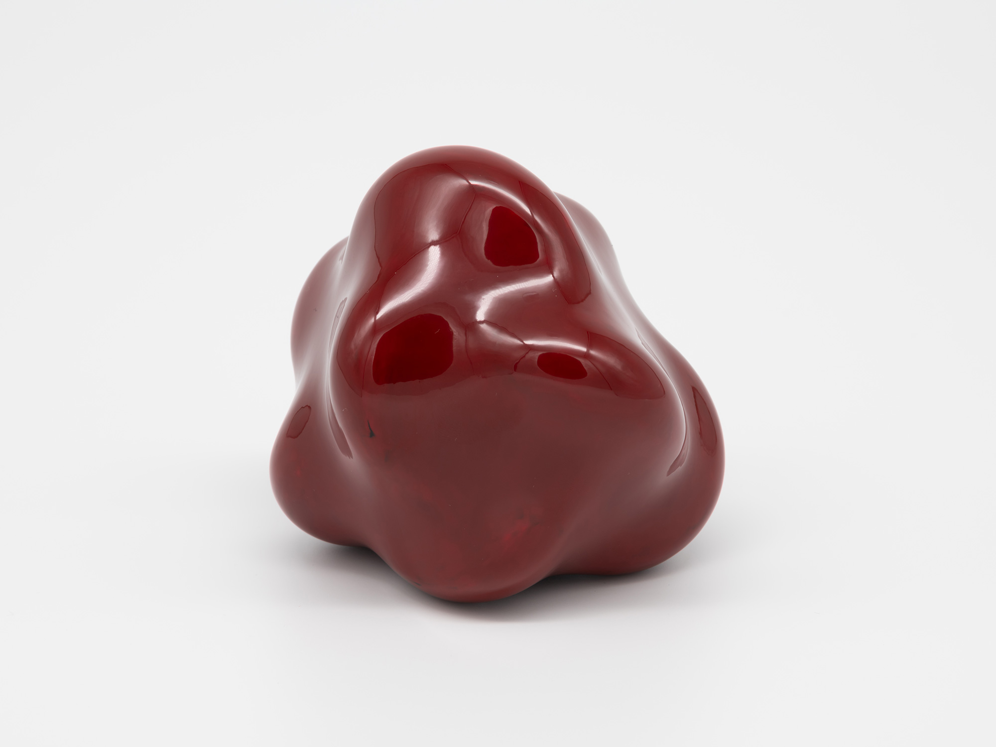 A side angle view of Genta Ishizuka's freestanding lacquer sculpture Untitled (star) against a...