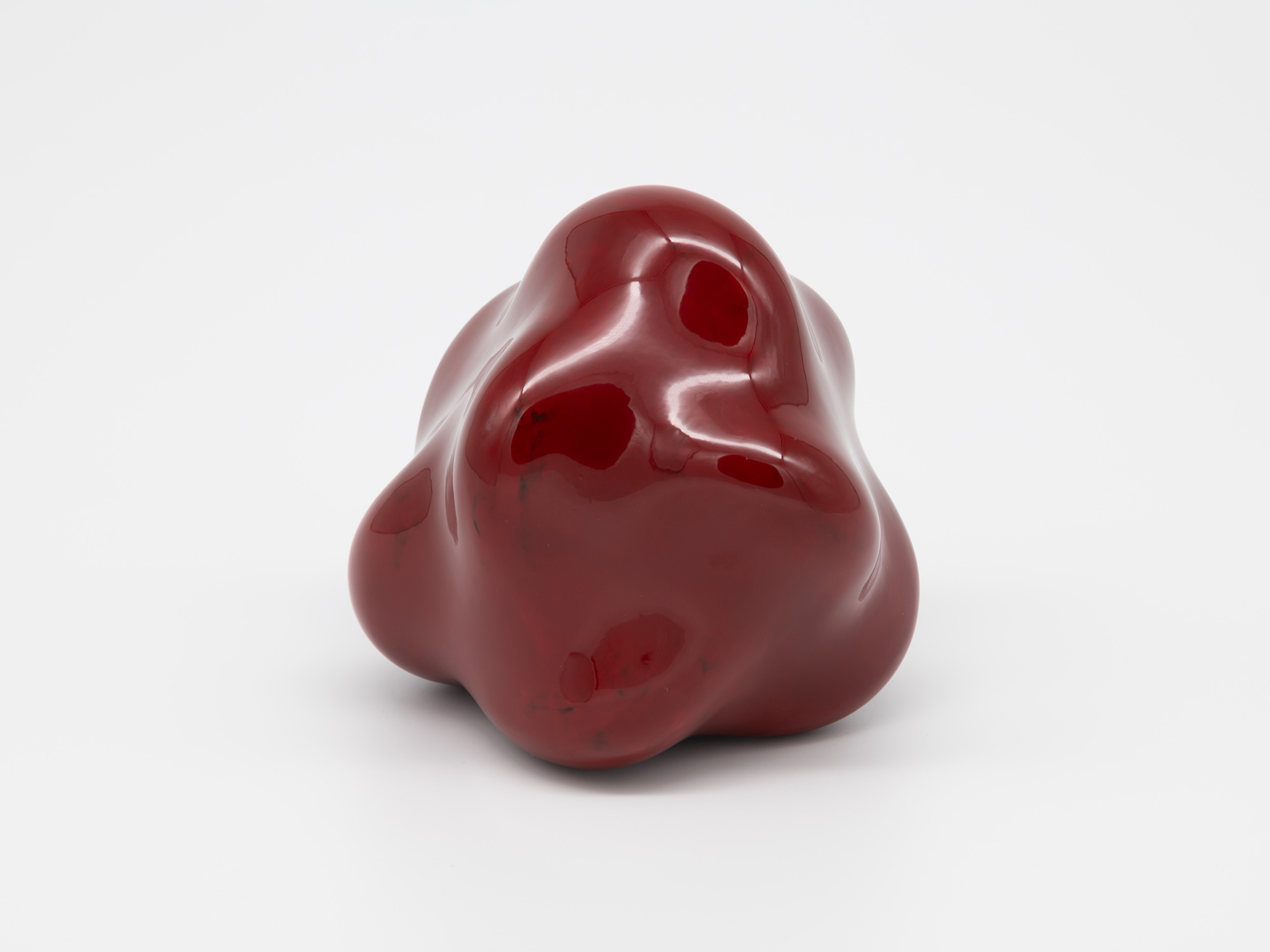 A side angle view of Genta Ishizuka's freestanding lacquer sculpture Untitled (star) against a...