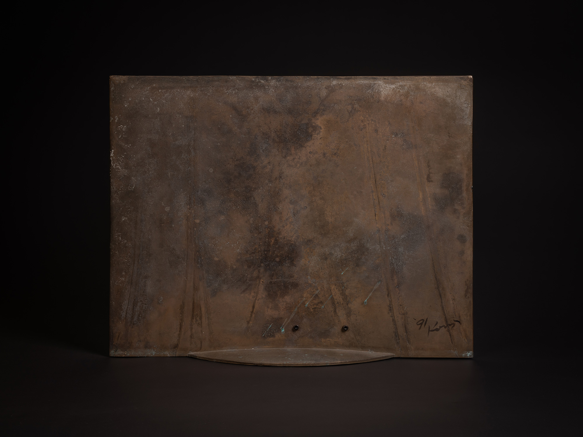 Back view of a bronze artwork by Koji Hatakeyama featuring a rectangular bronze panel with a mottled...