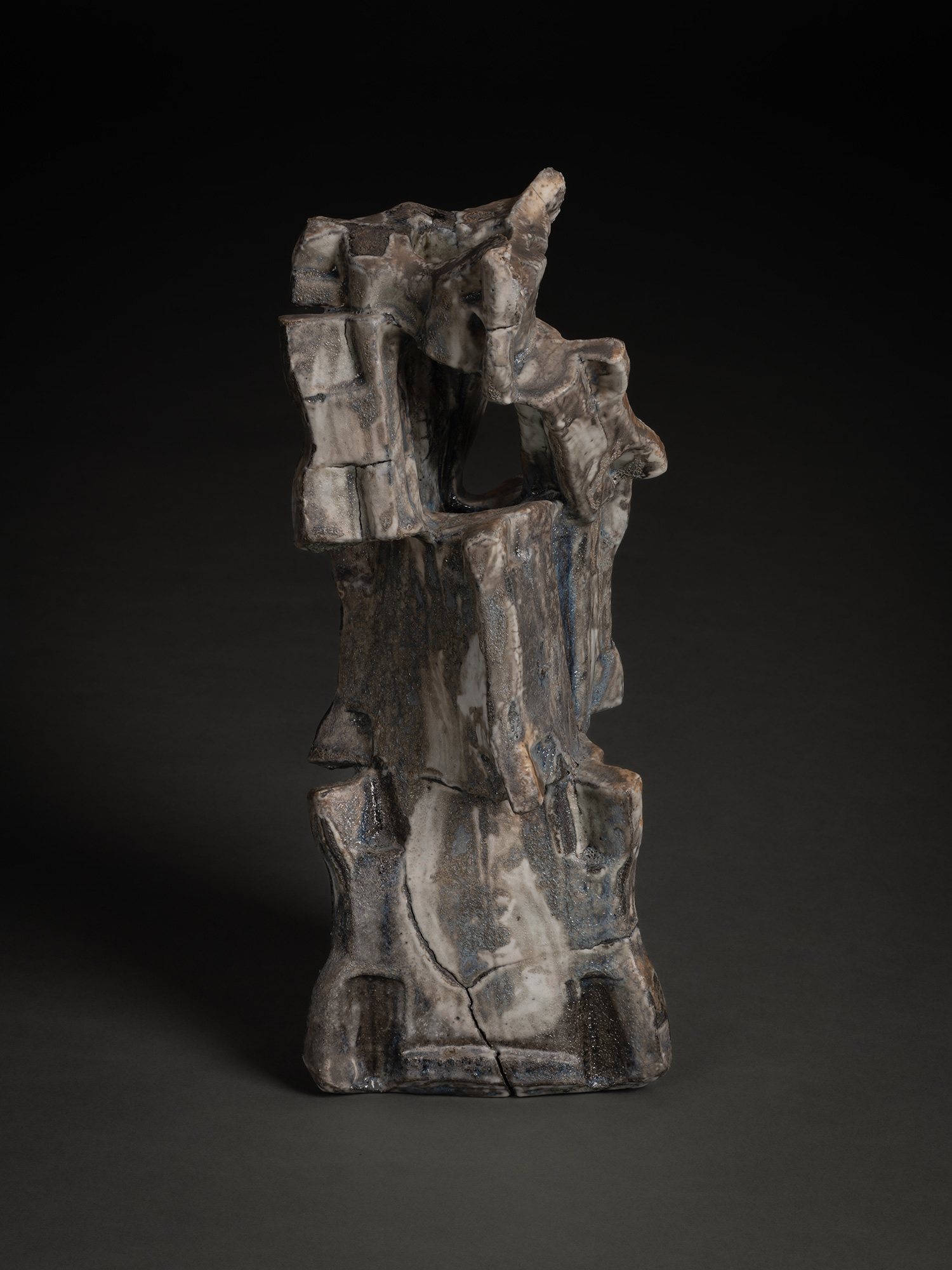 Volcano by Shōzō Michikawa is a tall sculptural ceramic form with a rugged, asymmetrical silhouette...