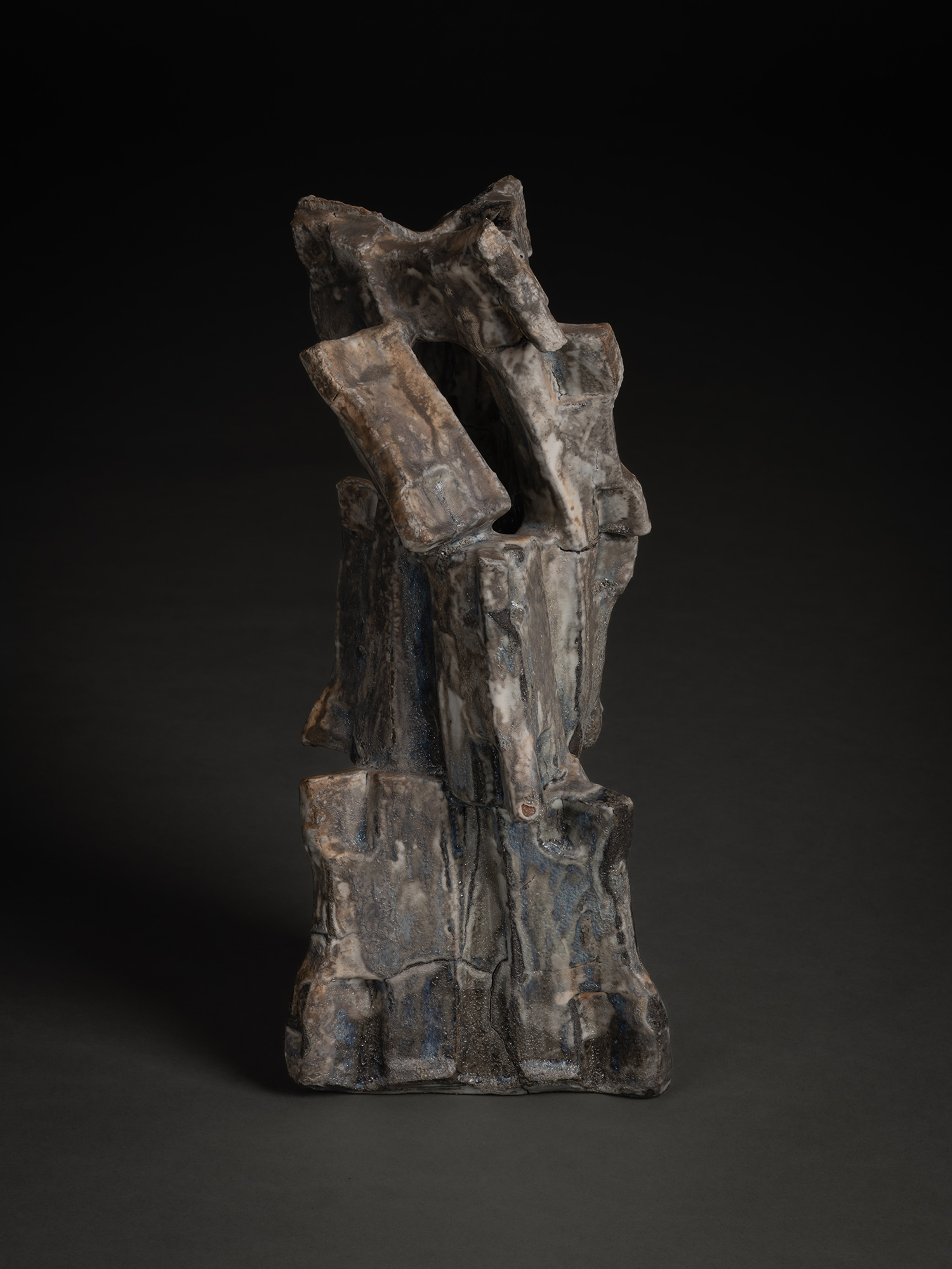 Volcano by Shōzō Michikawa is a tall sculptural ceramic form with a rugged, asymmetrical silhouette...