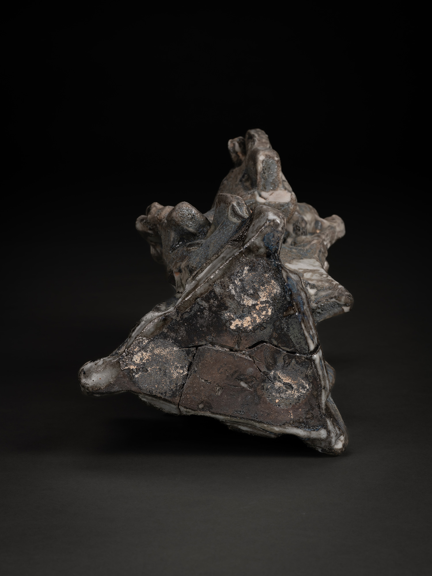 The underside of Volcano by Shōzō Michikawa reveals an irregular triangular foot with rough textured...