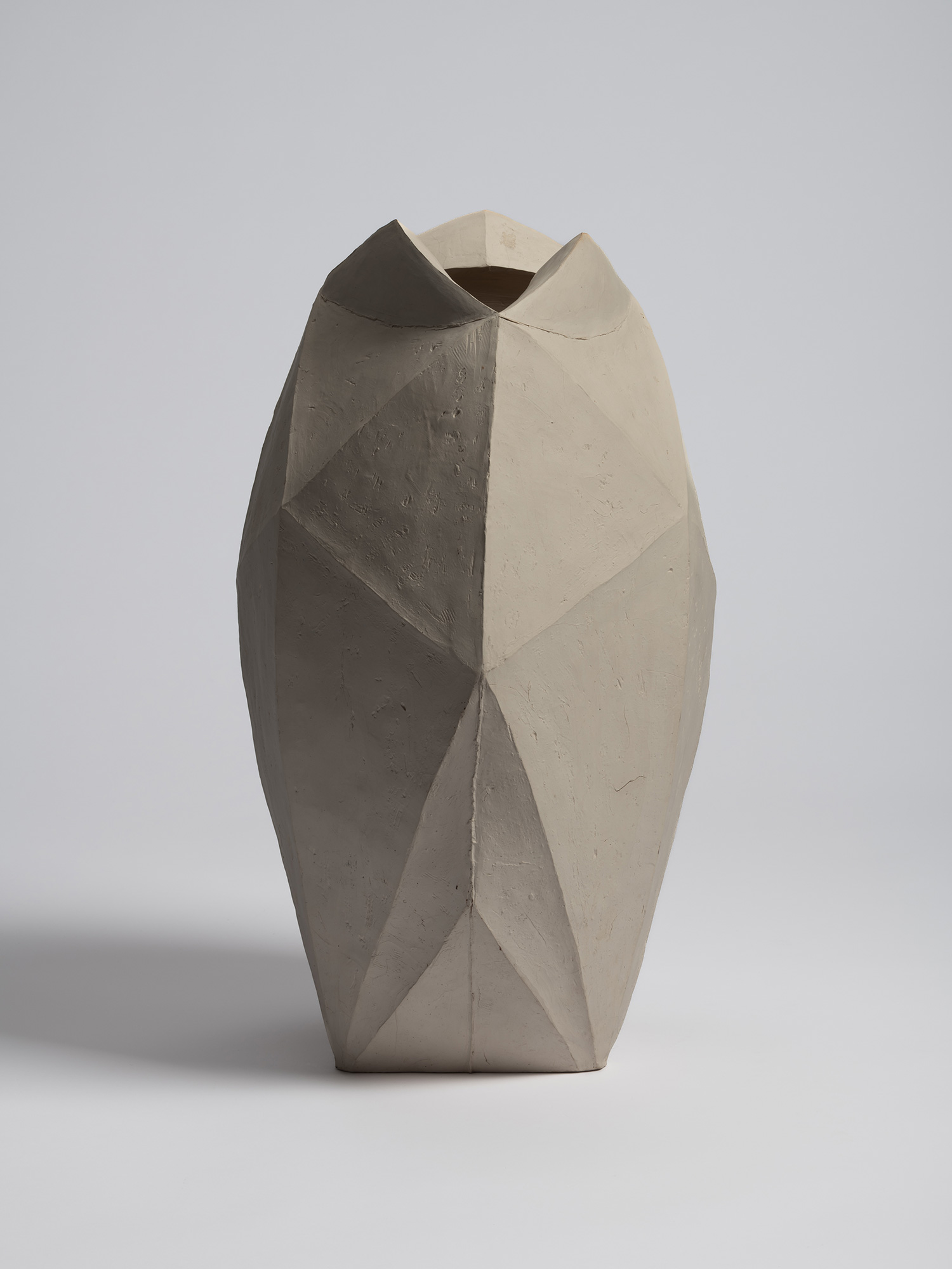 White multifaceted ceramic vase by Mori Tōgaku with sharply folded, paper-like planes and a matte...