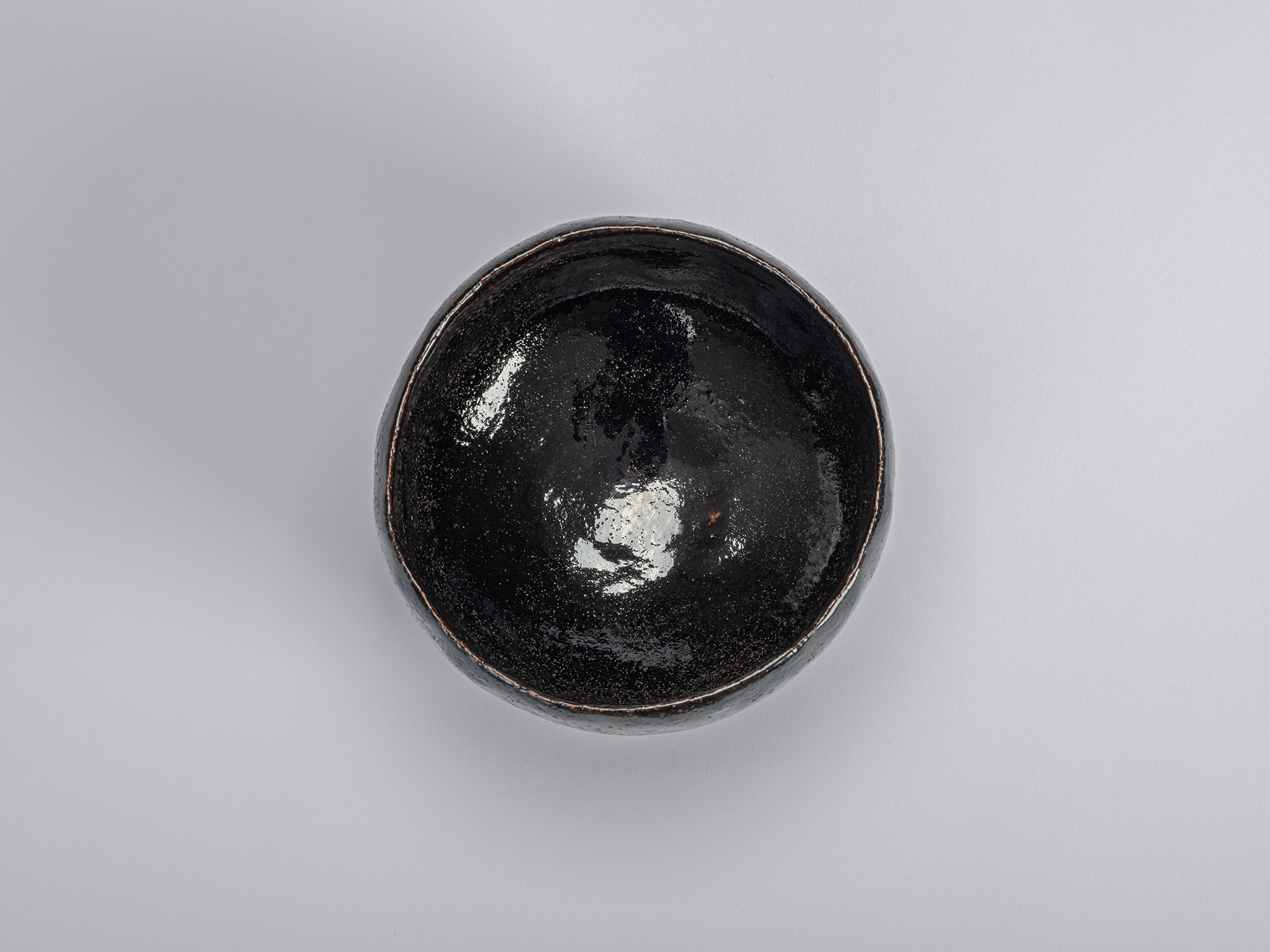 Interior (mikomi) view of the black Raku tea bowl Yokogumo (“Horizontal Clouds”) by Raku Dōnyū....