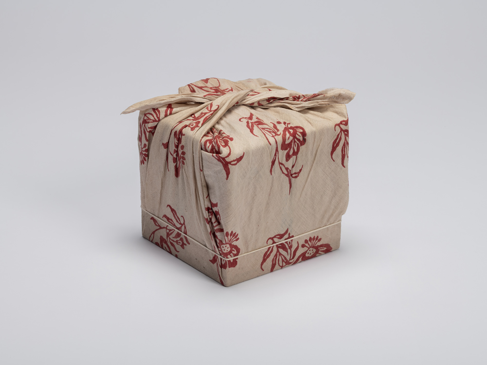 The third and innermost fabric layer enveloping the nested tomobako for the historic black Raku...