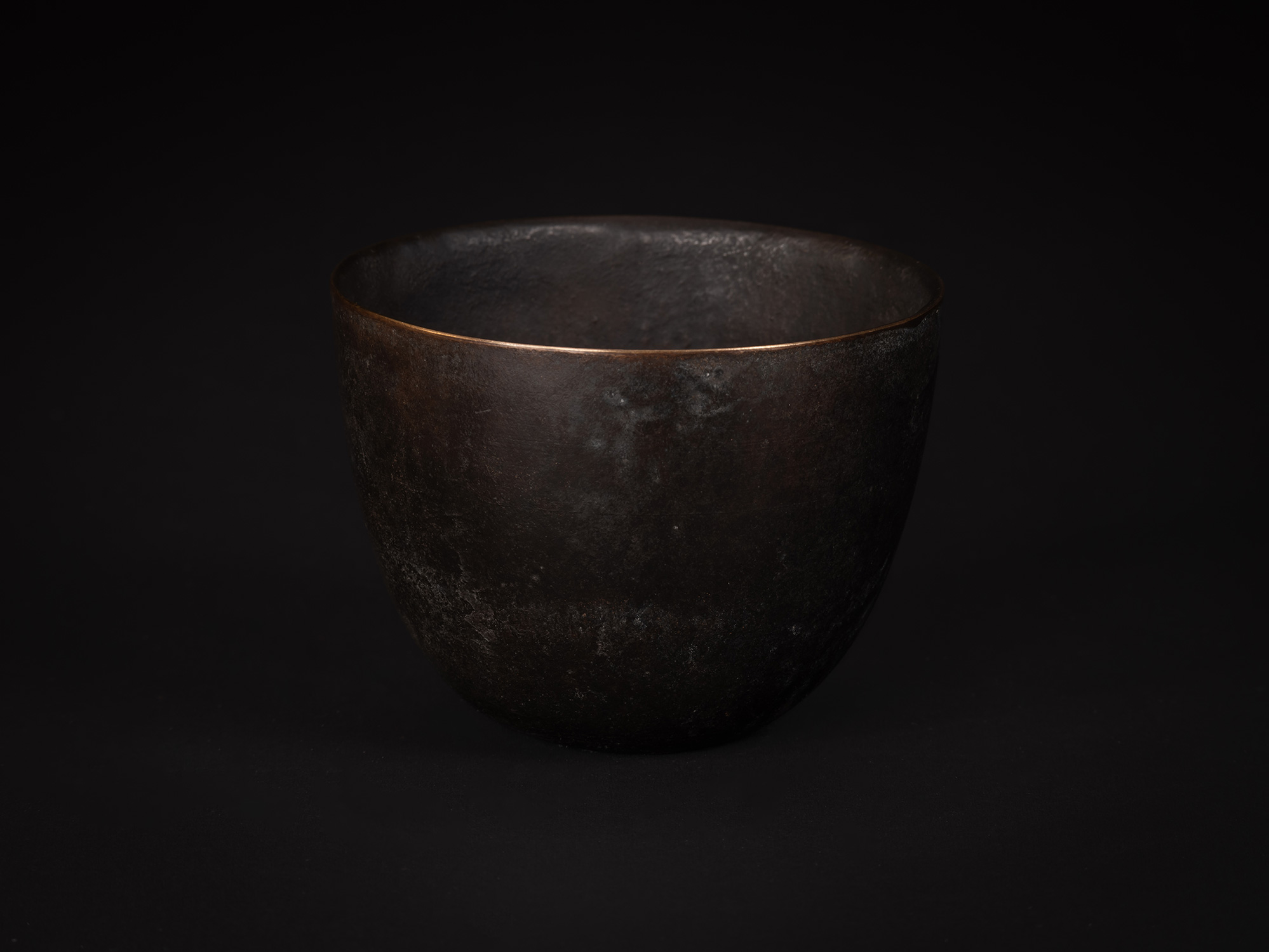 Bronze No. 8 by Koji Hatakeyama, viewed from the front, showing a rounded bronze vessel with a...