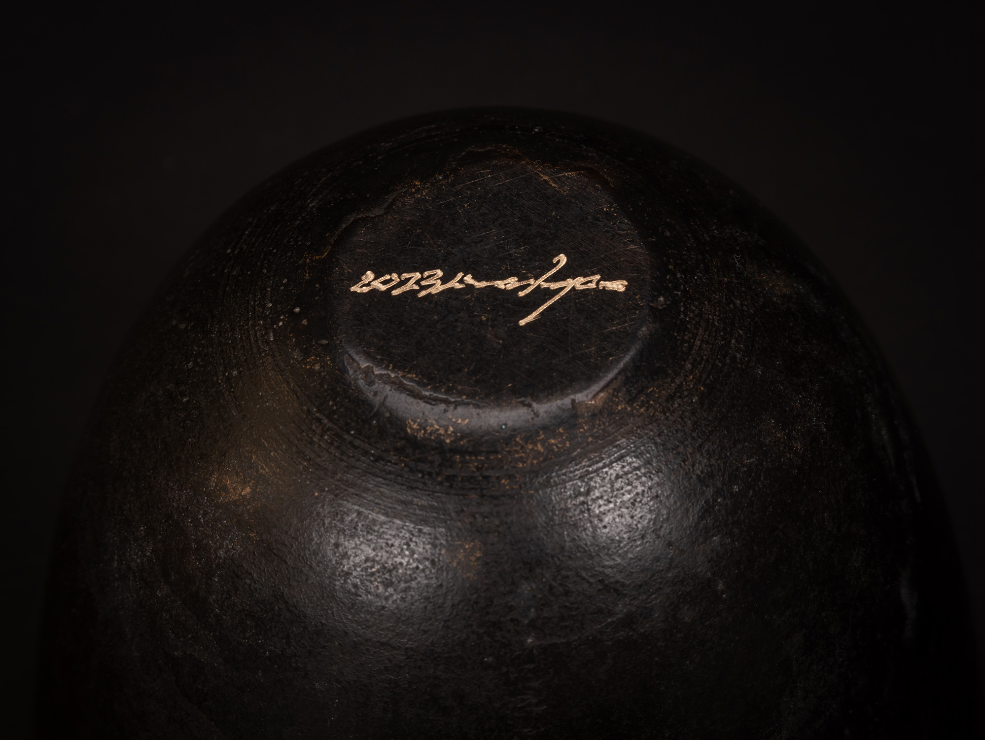 Underside detail of Bronze No. 8 by Koji Hatakeyama showing the artist’s engraved signature on...