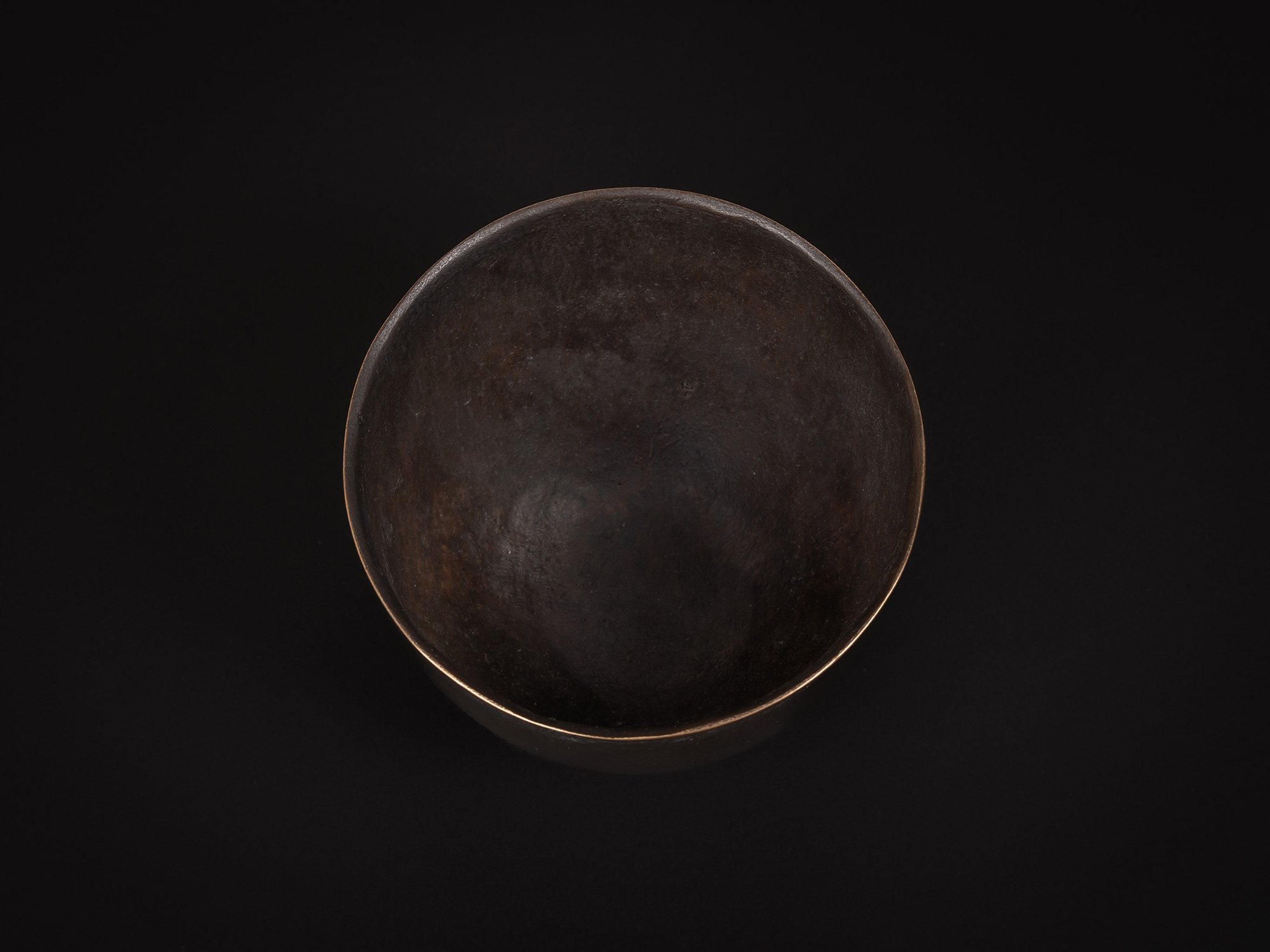 Aerial view of Bronze No. 8 by Koji Hatakeyama showing the circular opening and dark interior of...
