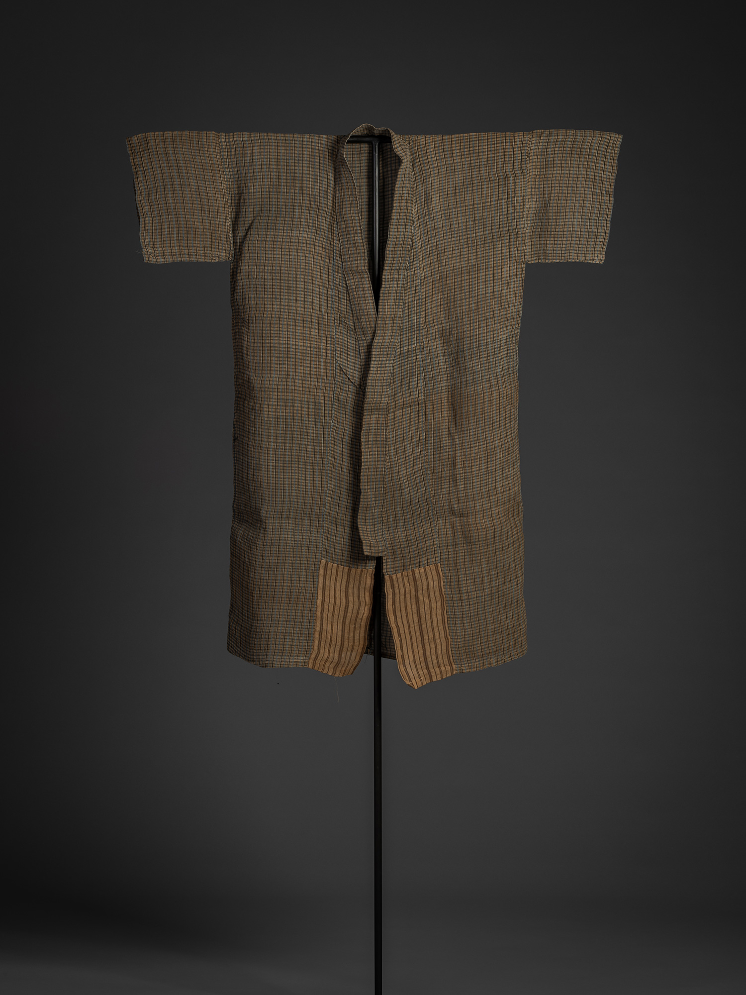 Full front view of a bashōfu kimono made from banana fiber and ramie, displayed on a black stand....