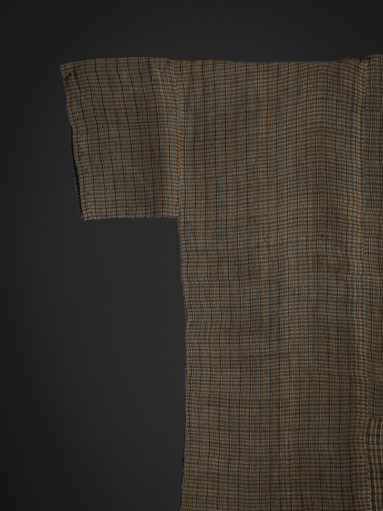 Close-up of the upper back right section of the bashōfu kimono. Fine brown, black, and muted blue...