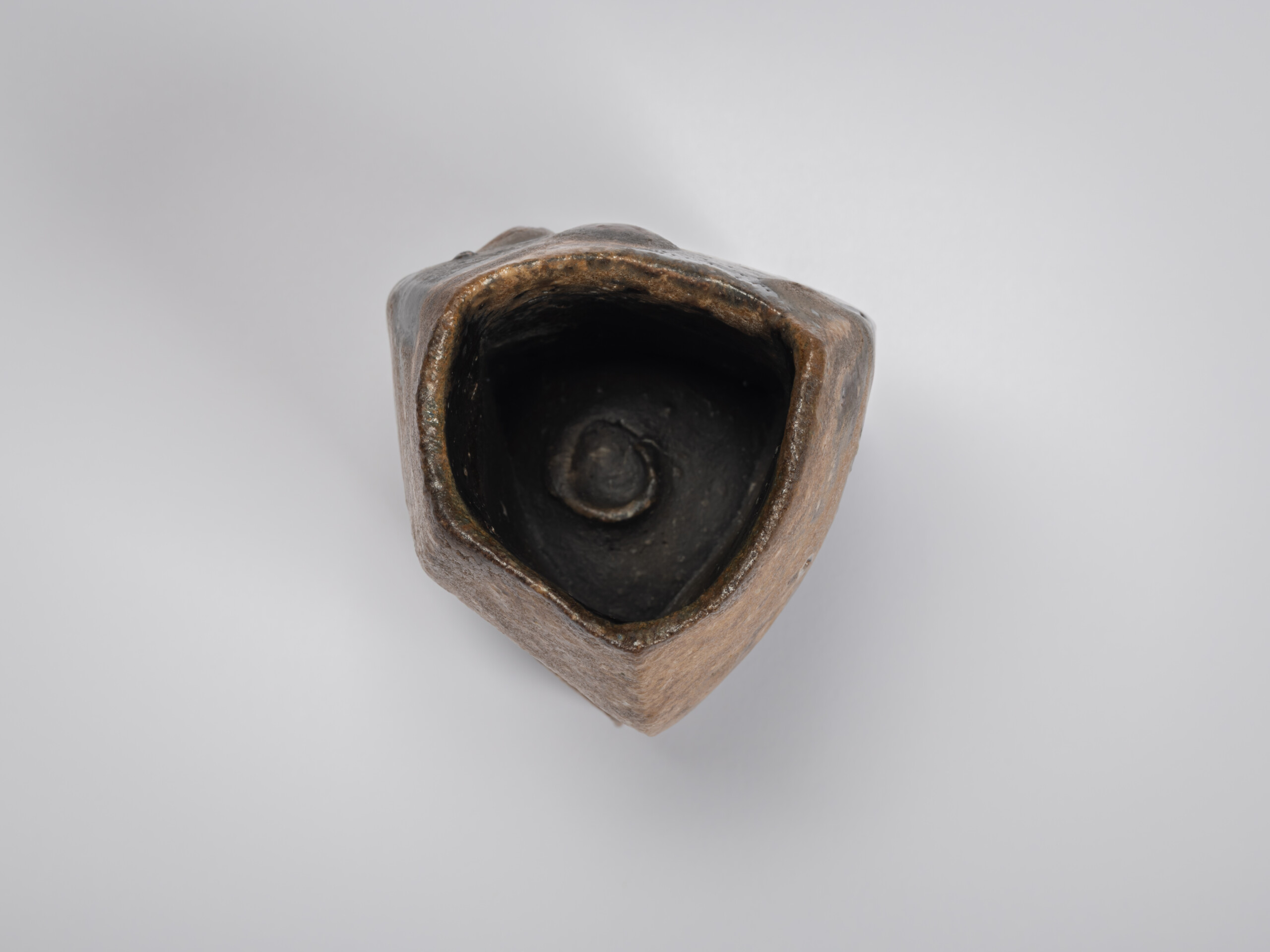 Overhead view of Black Guinomi by Ryuichi Kakurezaki showing the irregular triangular opening and...