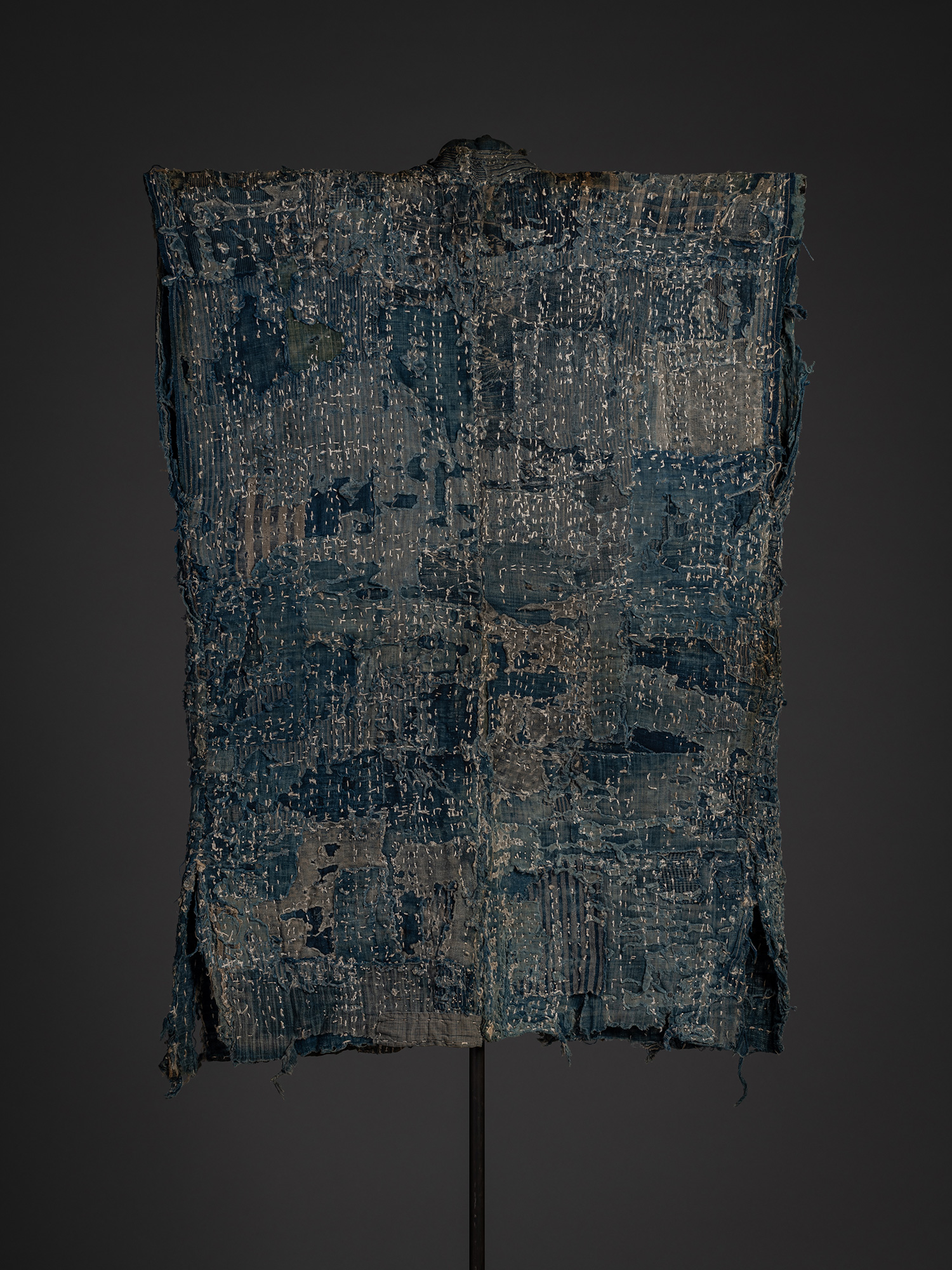 Full back view of the boro work coat. The entire surface is formed from overlapping indigo-dyed...