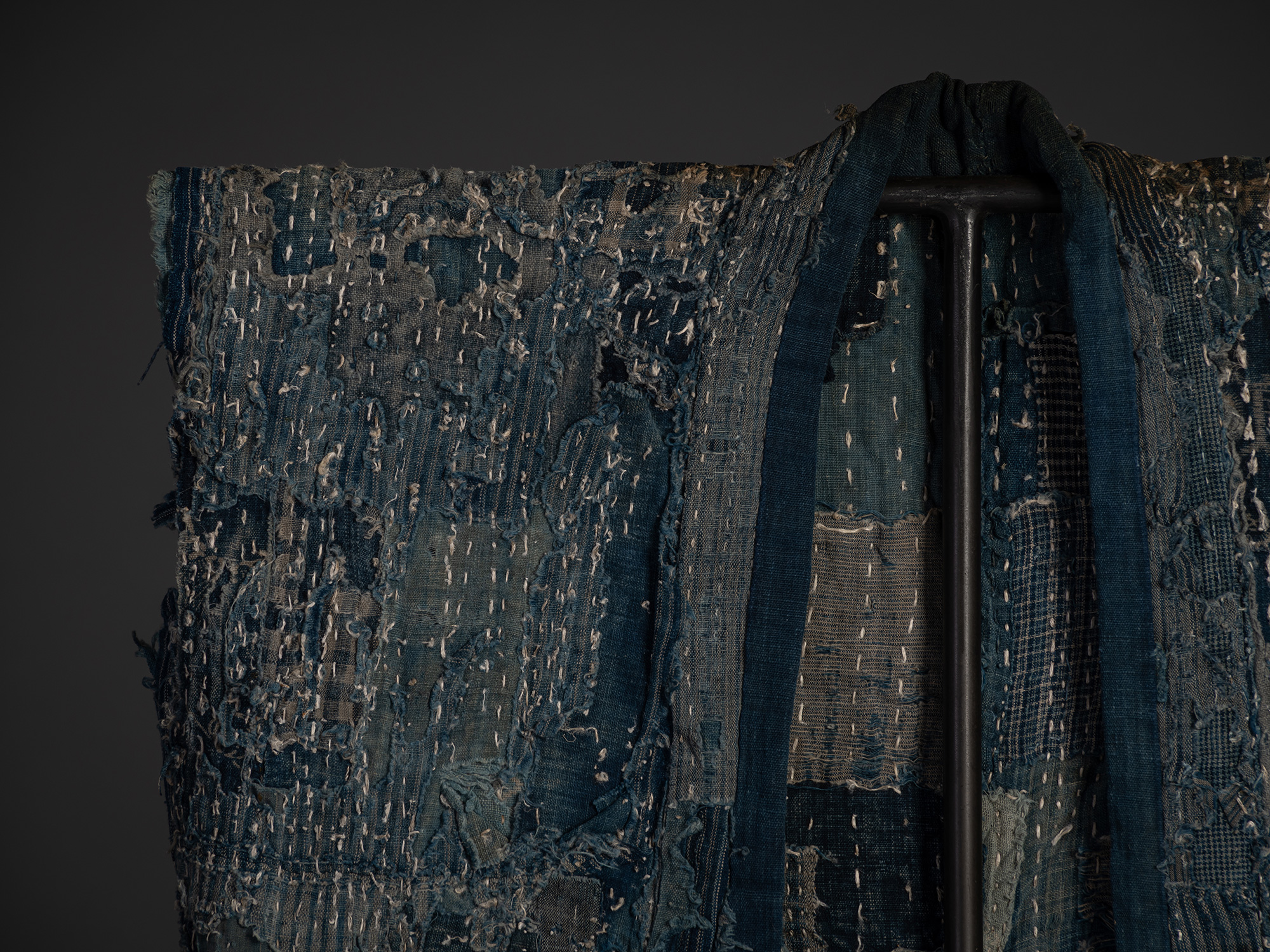 Boro work coat constructed from layers of indigo-dyed cotton and hemp textiles. The sleeveless...