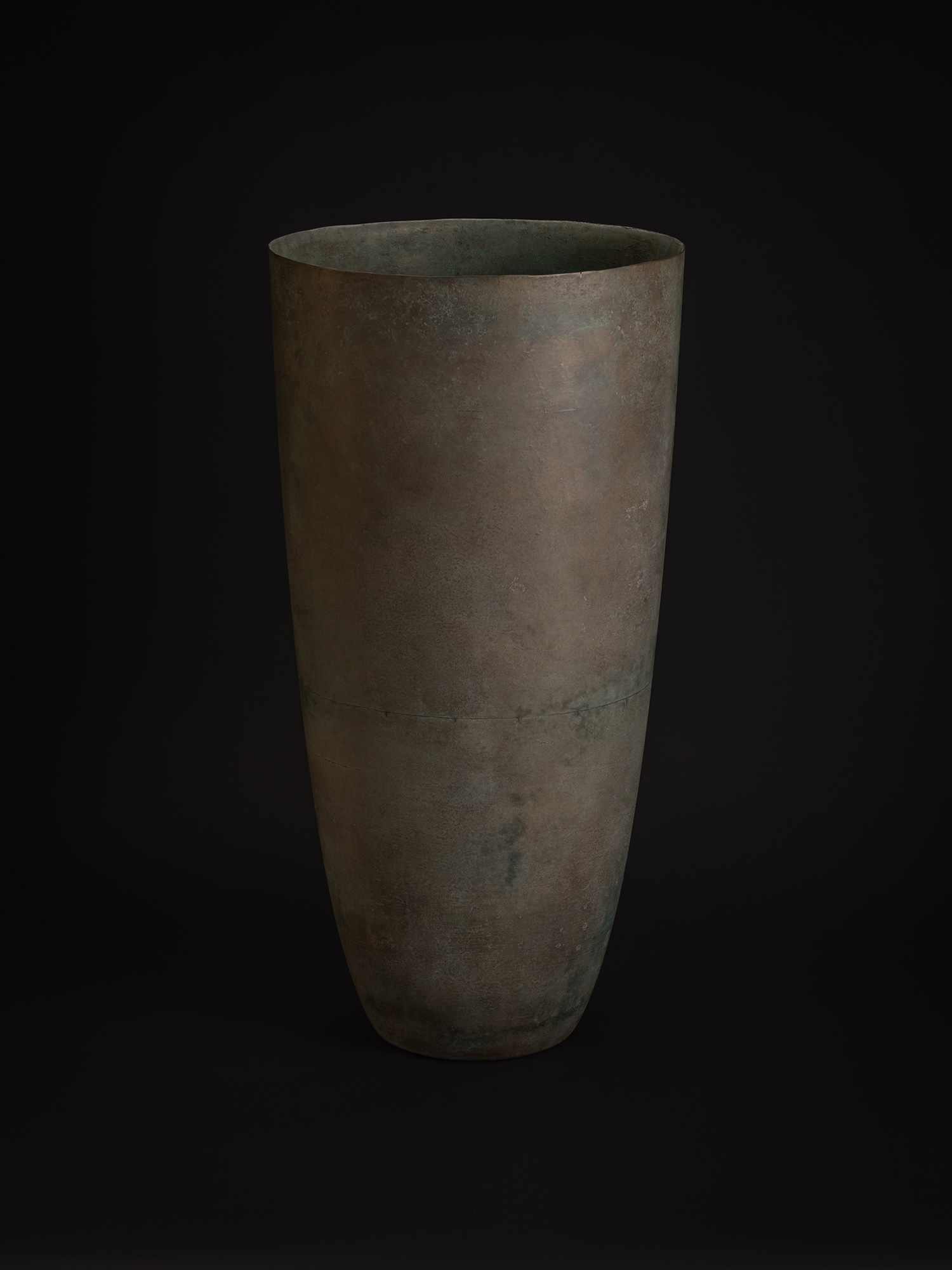 Viewed from a slight angle, the vessel's elongated silhouette and gently flaring rim become more...