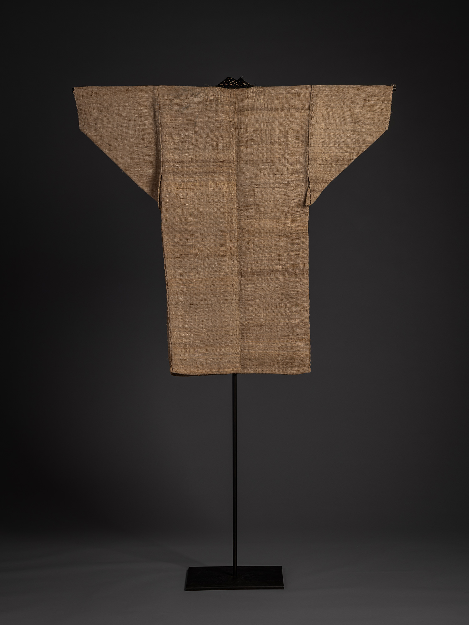 Full back view of a Japanese fujifu robe displayed on a stand. Woven from natural brown wisteria...