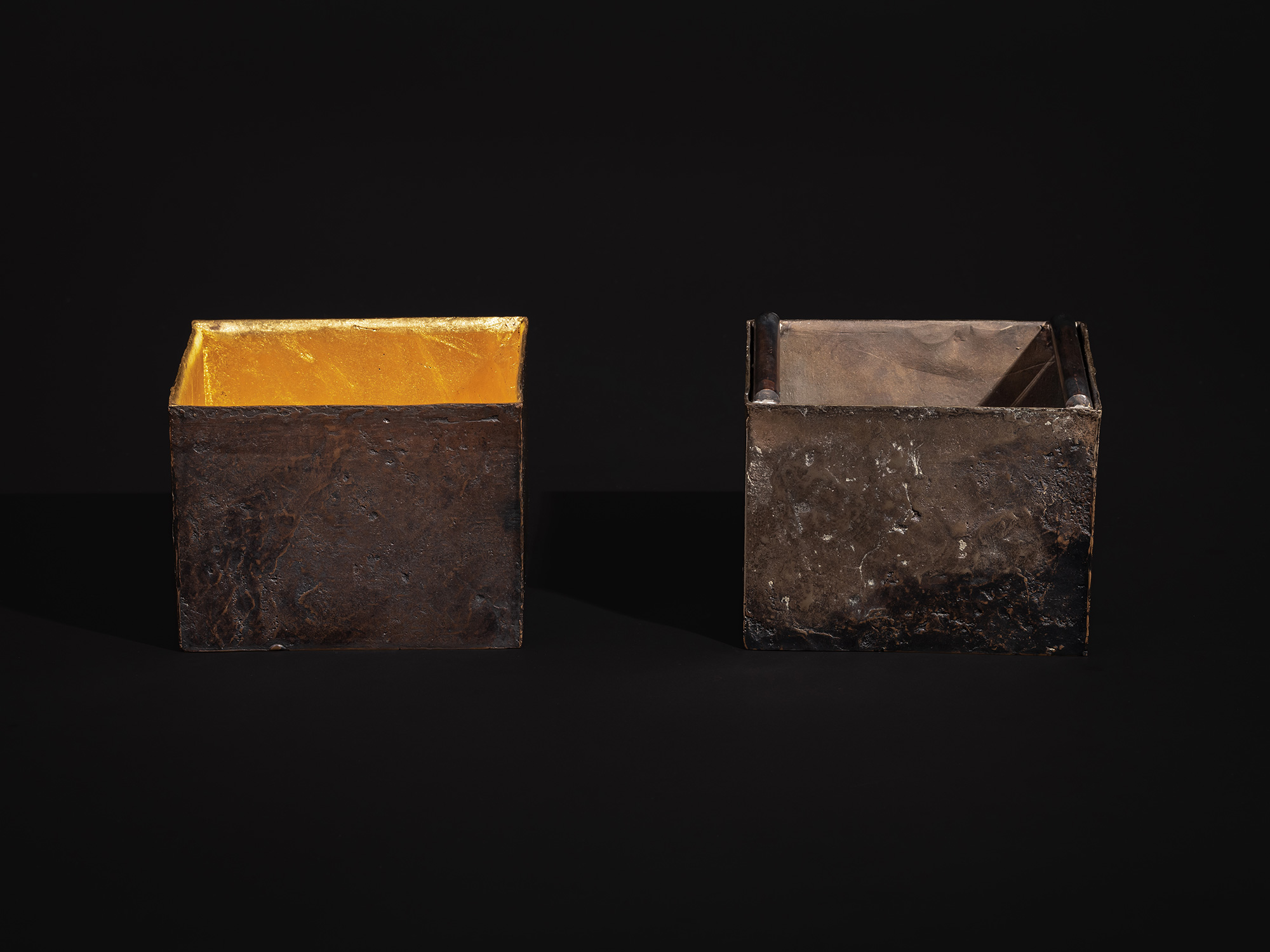 Two rectangular bronze box elements from Inner Existence by Hatakeyama are displayed side by side...