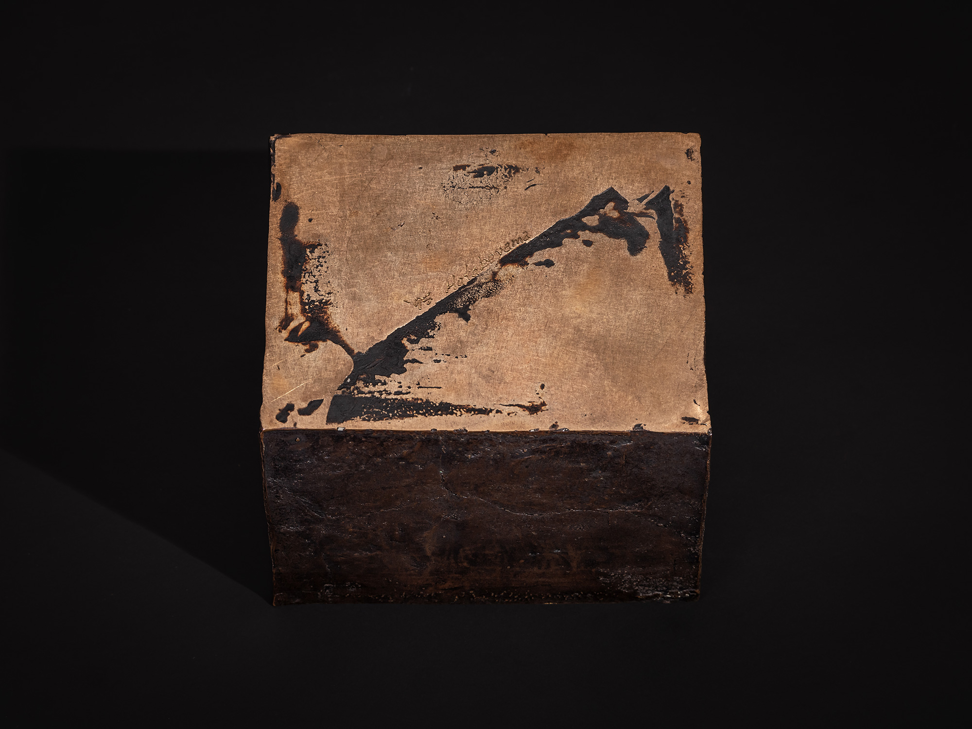 The underside of Inner Existence features a broad bronze surface display of exposed metal, dark...