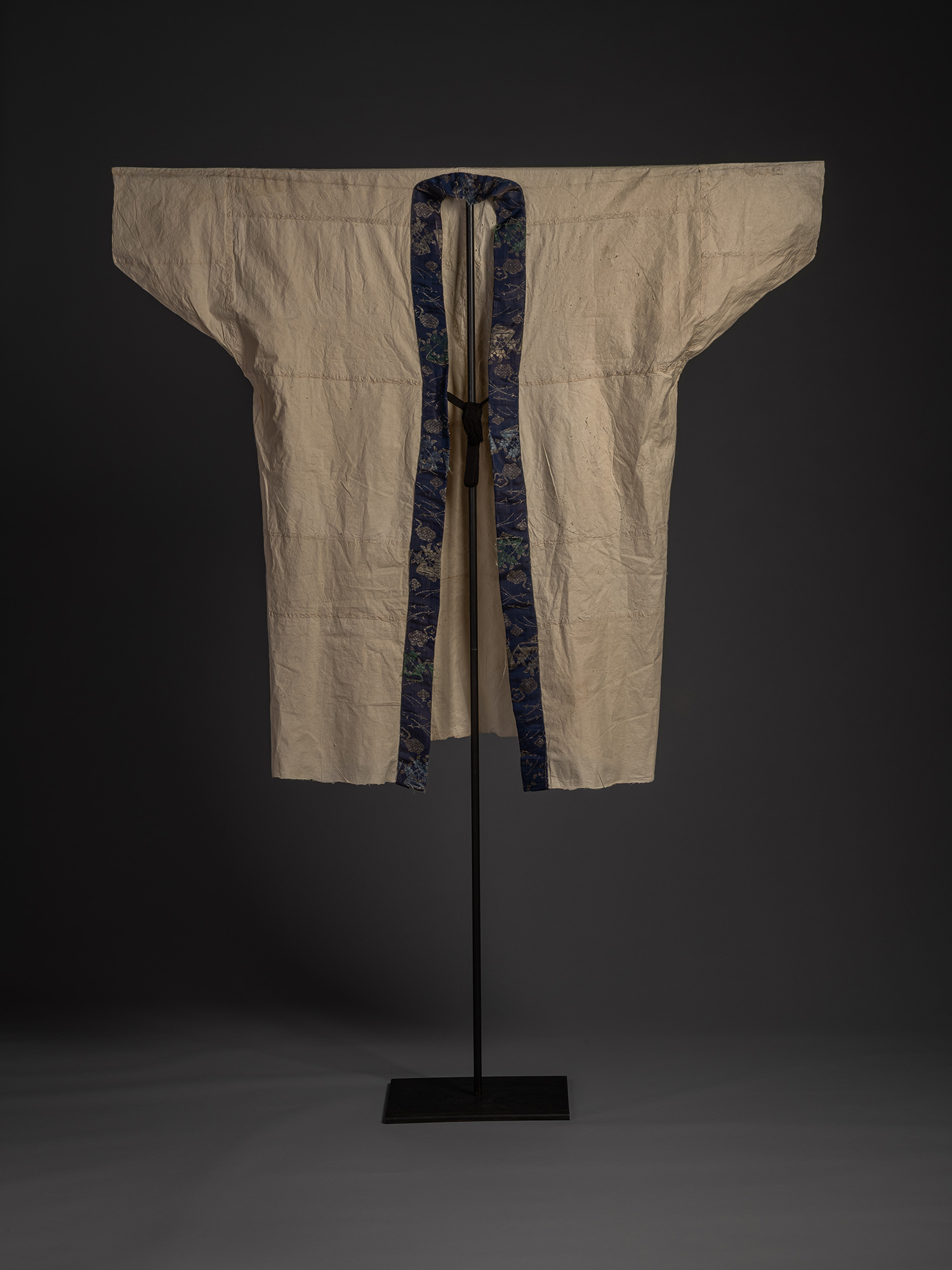 Full front view of a kamiko surcoat displayed on a black stand. The garment is constructed from...