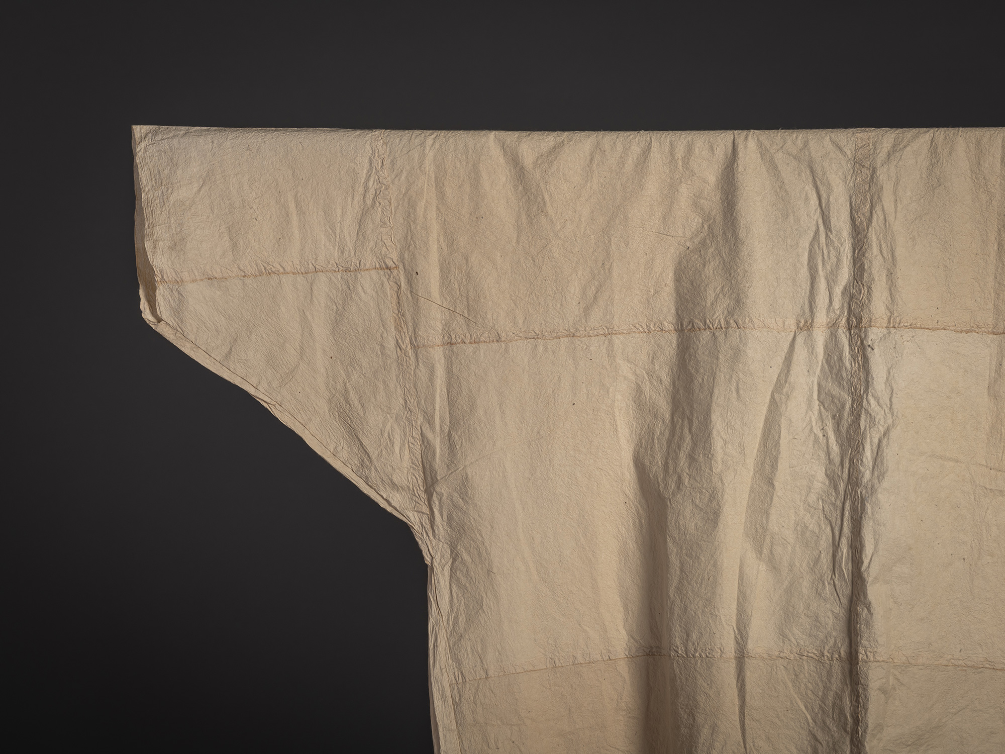 Close-up of the upper left sleeve and shoulder of a kamiko surcoat made from mulberry bast paper....