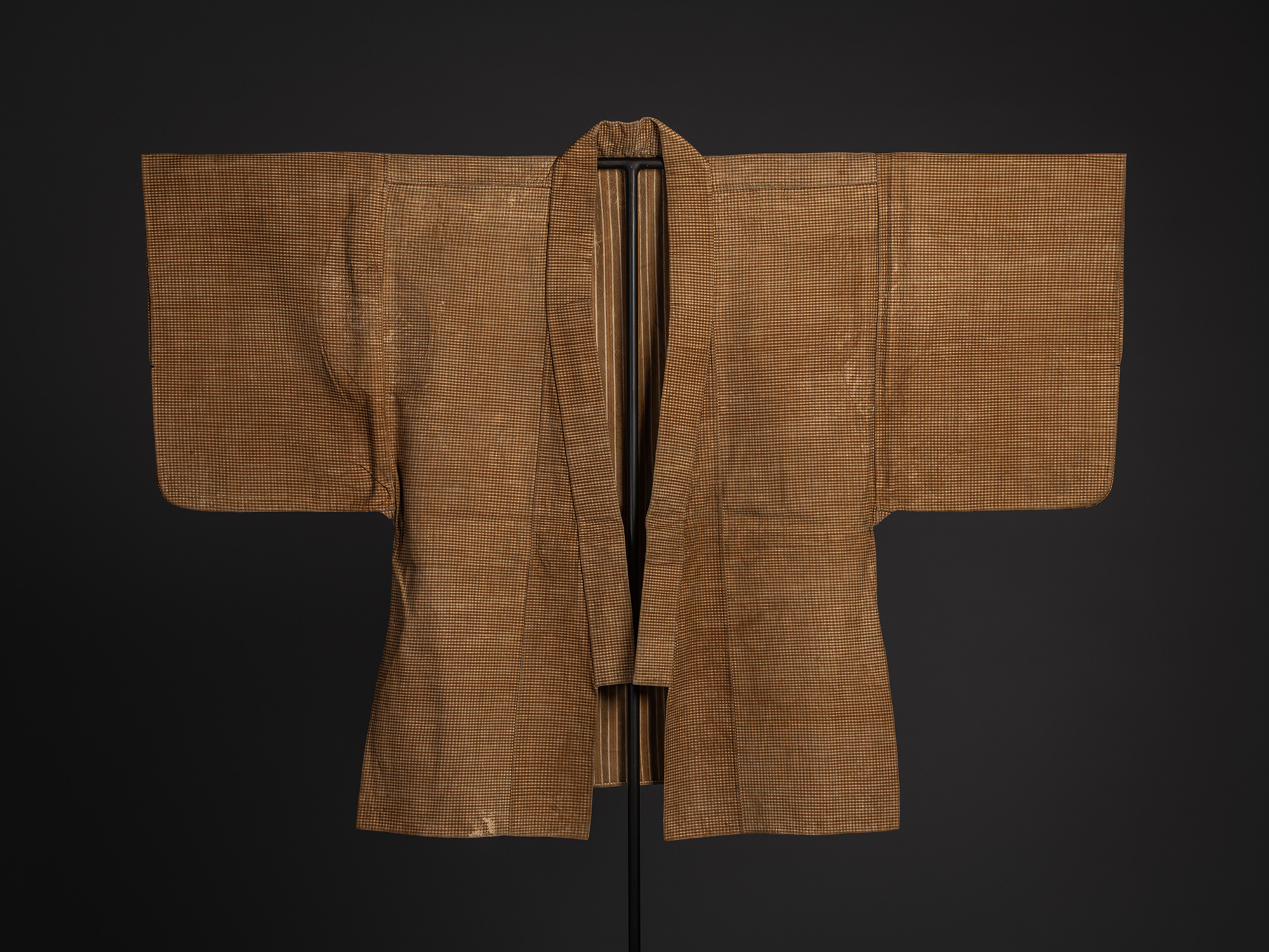Full front view of the Japanese kawabaori displayed open on a stand. The deerskin overcoat features...