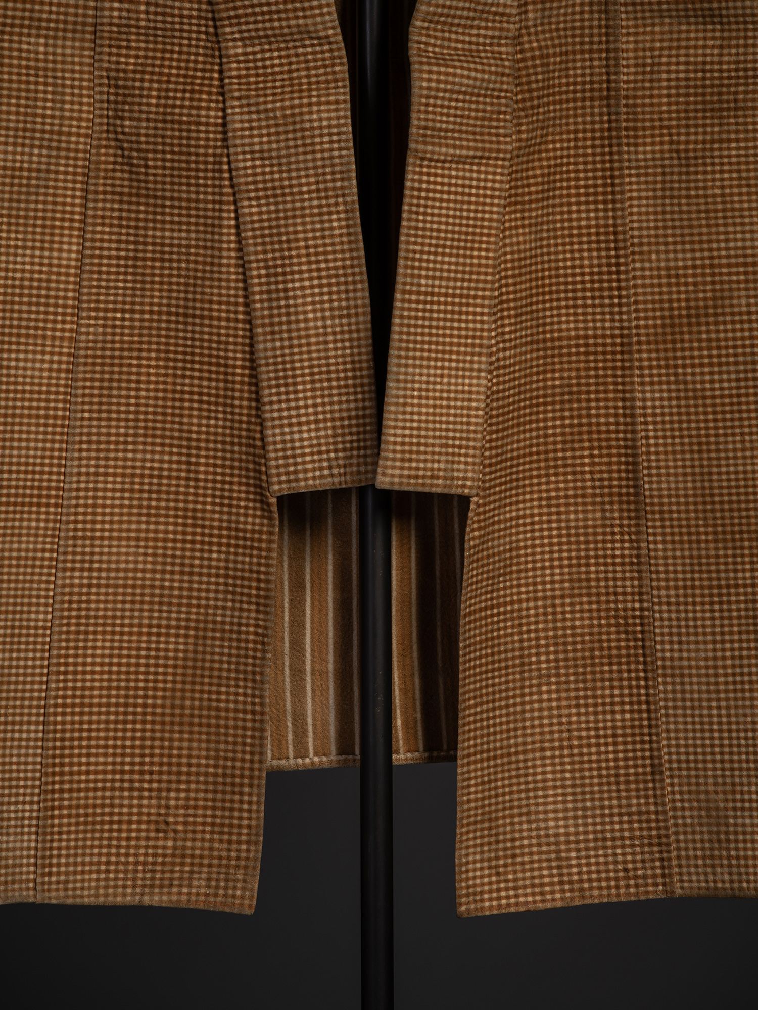 Close-up of the front opening and hanging lapels of the kawabaori. The small check pattern covers...