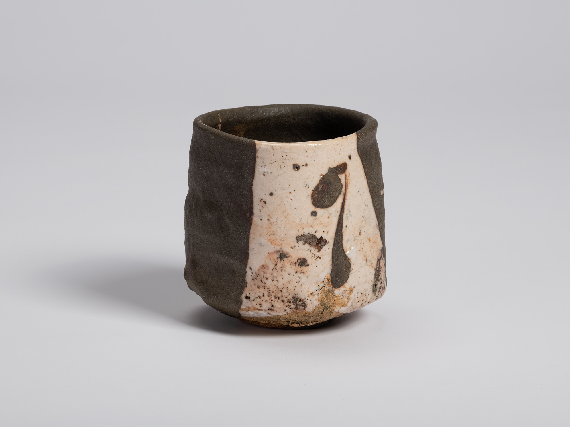 View of the bowl where the white glazed section returns into view. Black brushwork, speckling,...