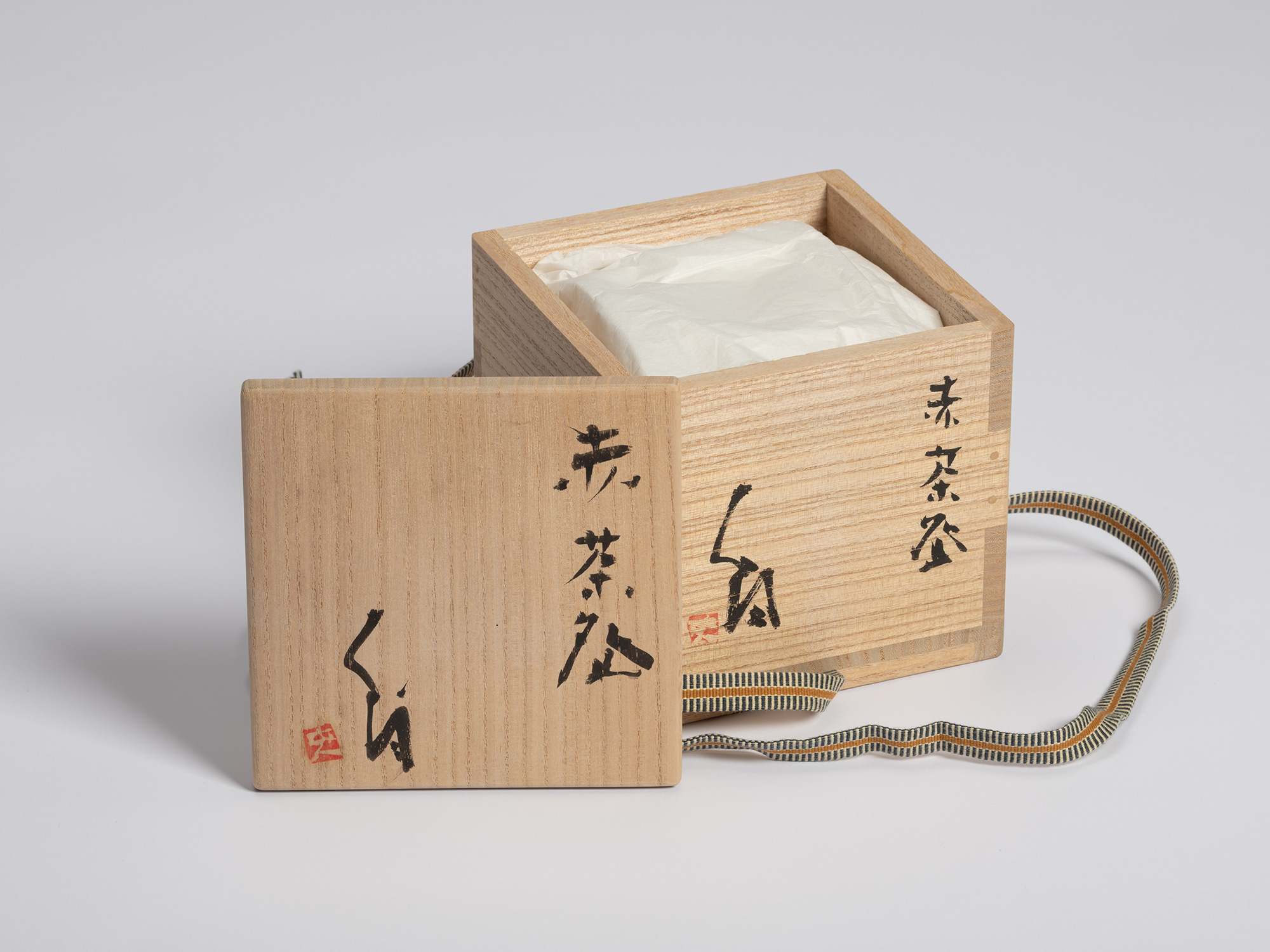 Square wooden paulownia storage box shown open against a seamless light grey background. The square...