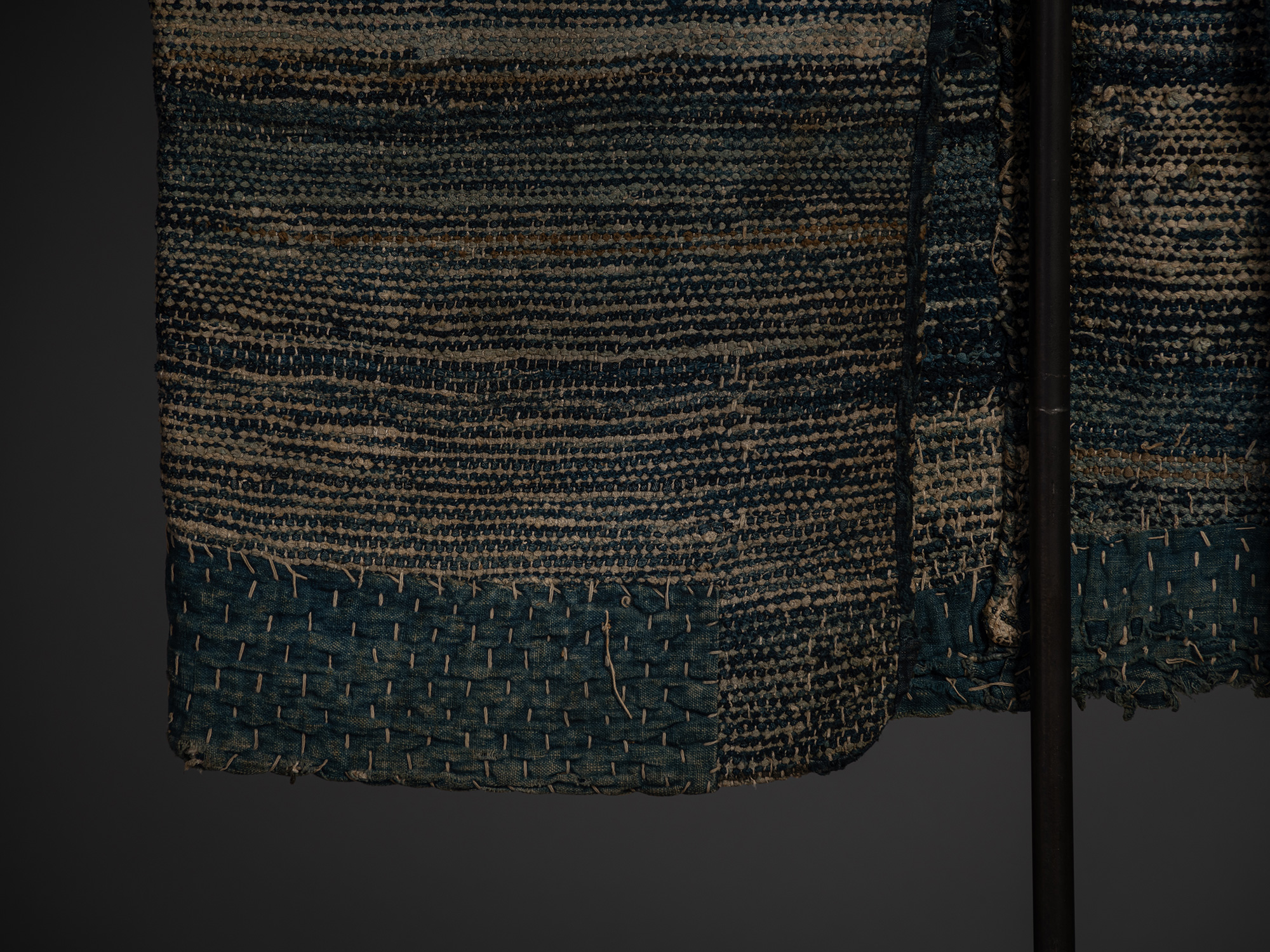 Detail of the lower front of the sakiori hanten showing heavily textured recycled-weave fabric...