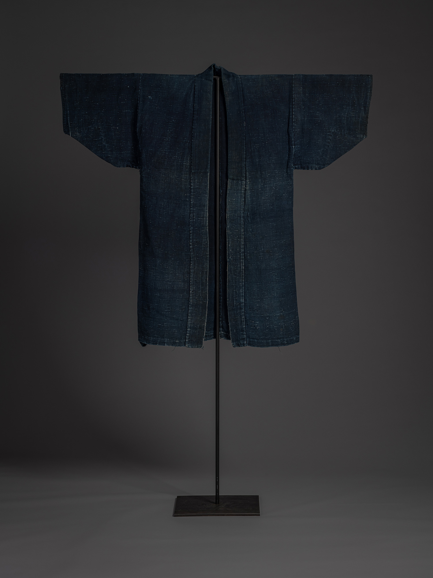 Full front view of a Shifu kimono displayed on a museum stand. The unlined garment is woven from...