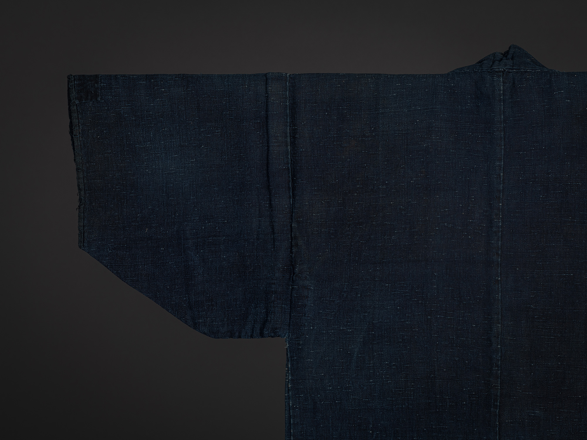 Close-up of the upper back of the Shifu kimono showing the left sleeve, shoulder, and center back...